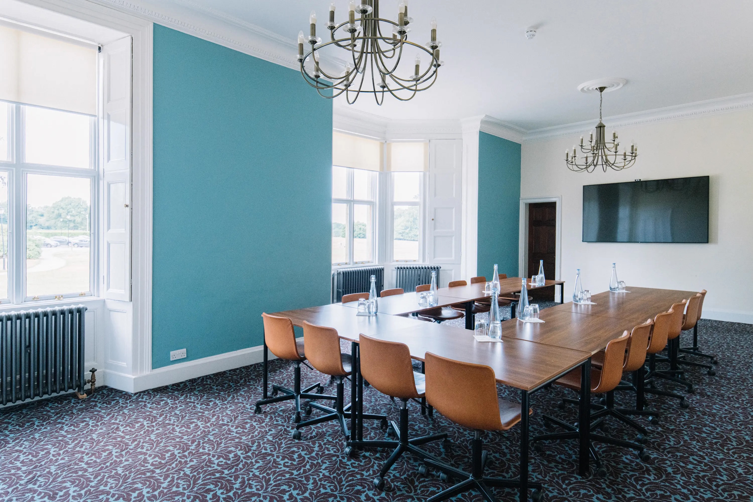 Meeting room at Ashridge House, Hertfordshire with long wooden table for professional gatherings.