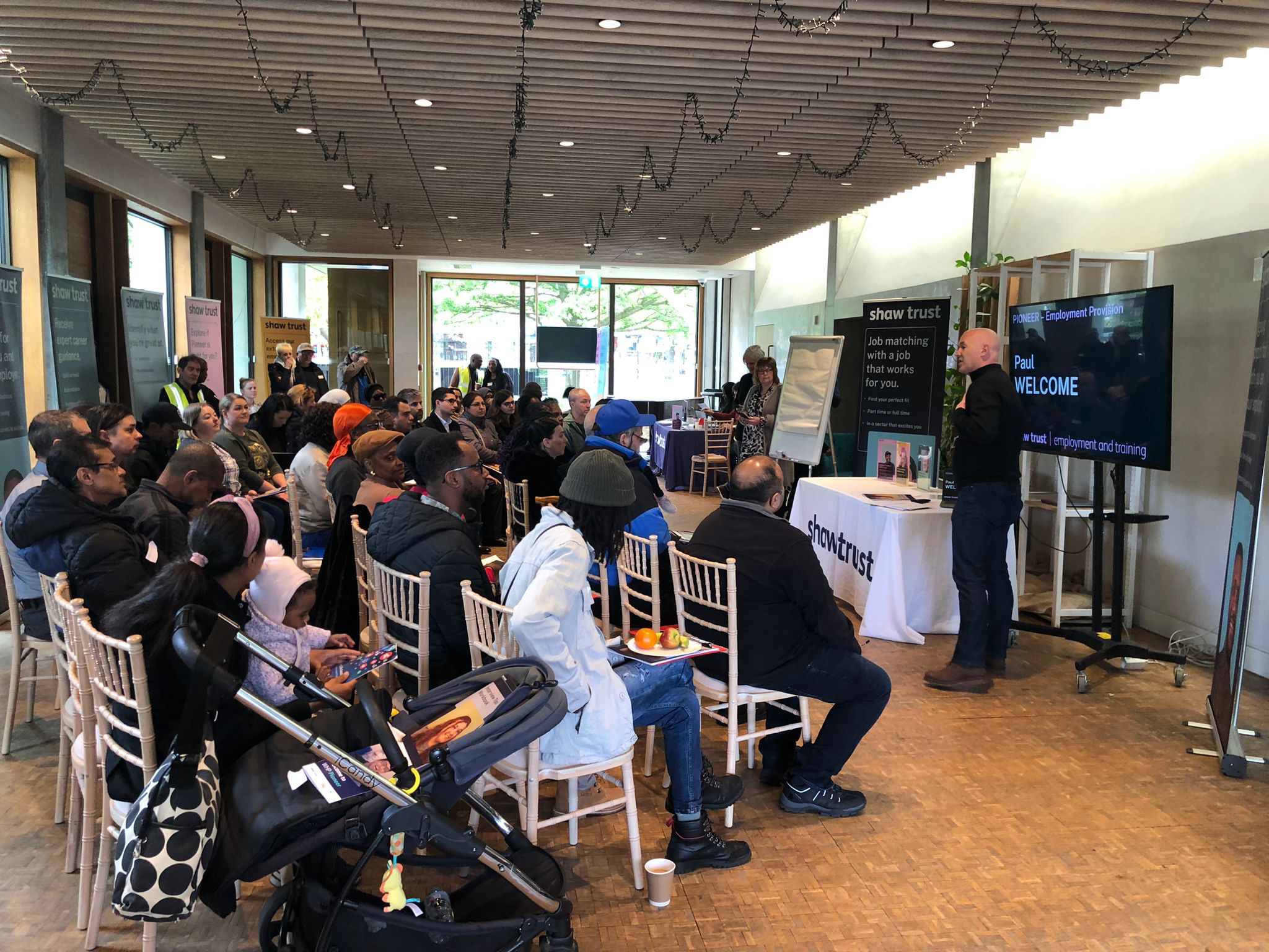 Soane's Garden Room event with engaged audience and clear signage for effective interaction.