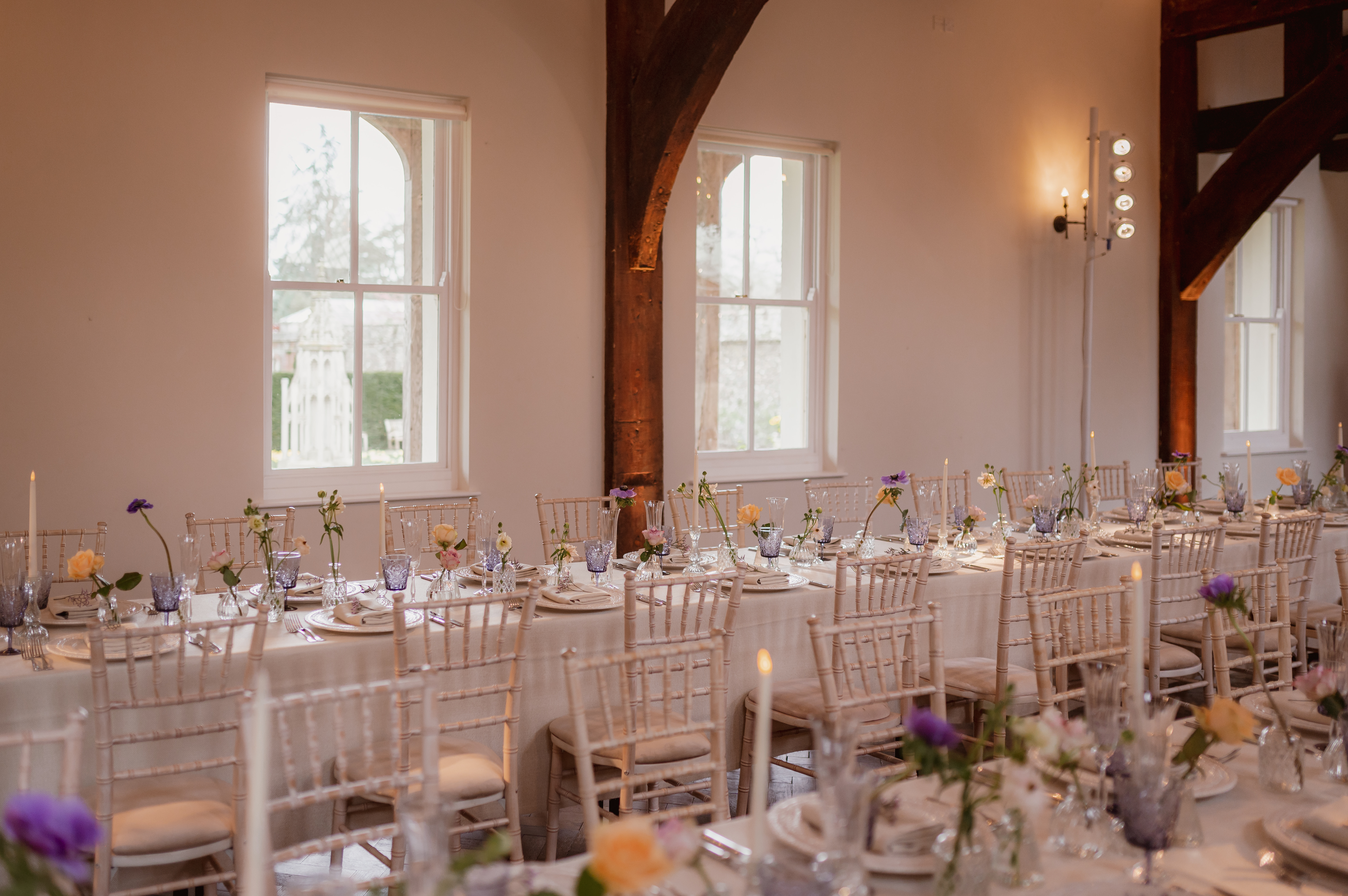 Elegant Monks Barn event space with long tables, ideal for weddings and corporate events.