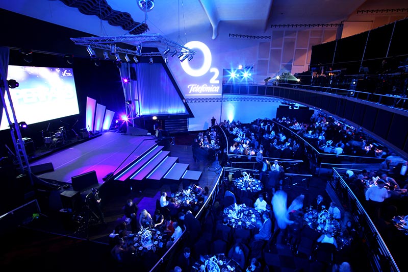 Vibrant event space in Athena with elegant tables for presentations and performances.