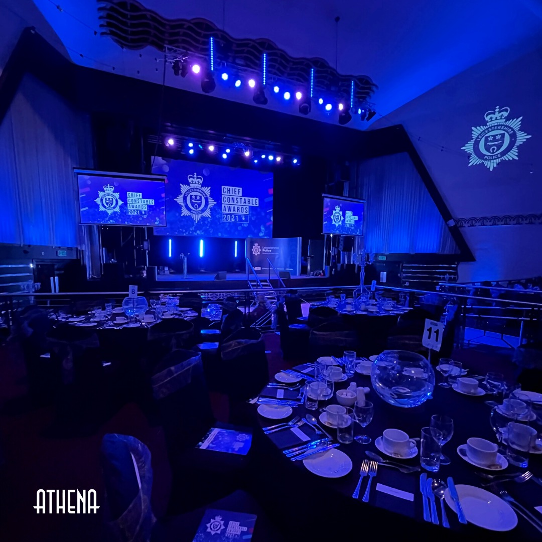 Elegant event space in Athena with stage, dynamic lighting for presentations or galas.