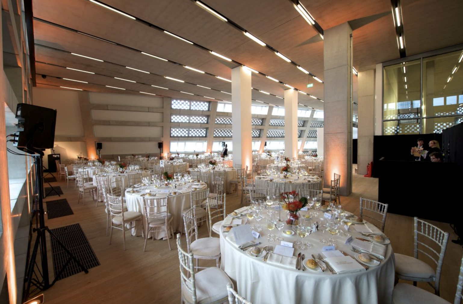Elegant event space in Tate Modern with round tables, ideal for networking and celebrations.