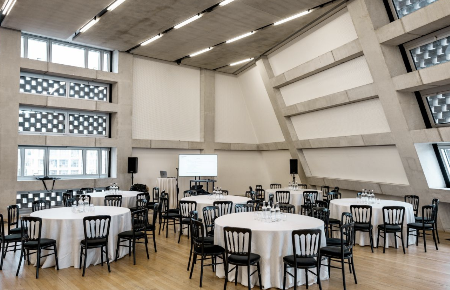 Modern event space in Tate Modern with round tables, ideal for corporate meetings and banquets.