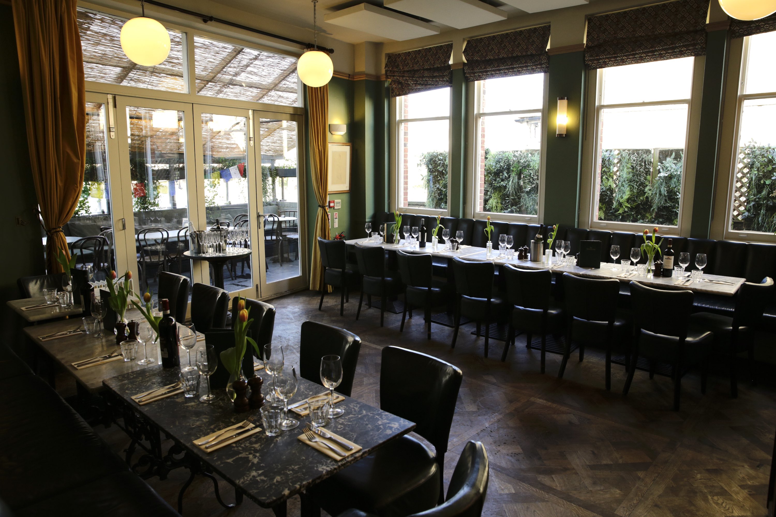 Private dining room with parquet flooring for corporate board meetings and networking events.