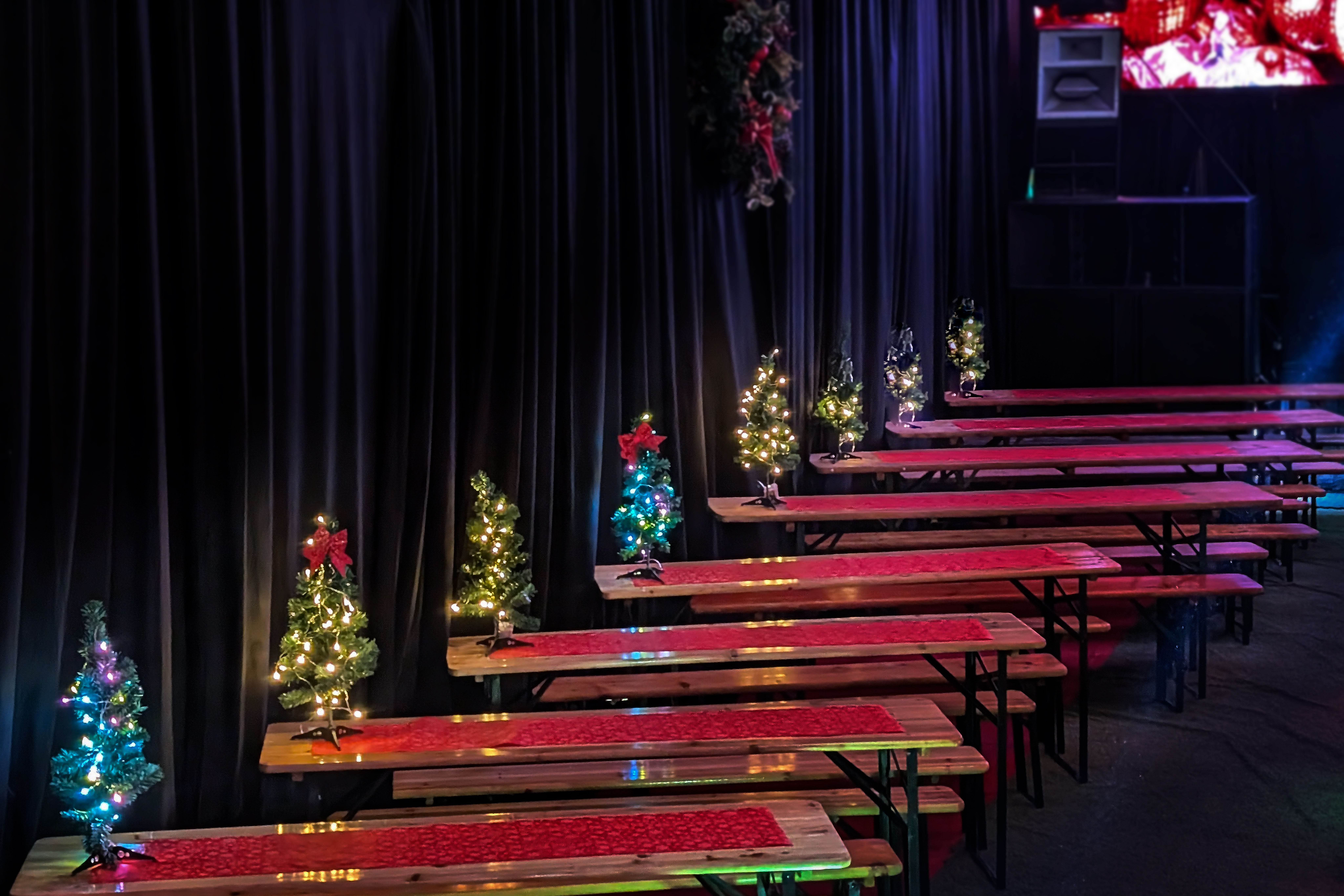UnderTheArches Fibre holiday event with tiered beer garden benches for festive corporate gatherings.