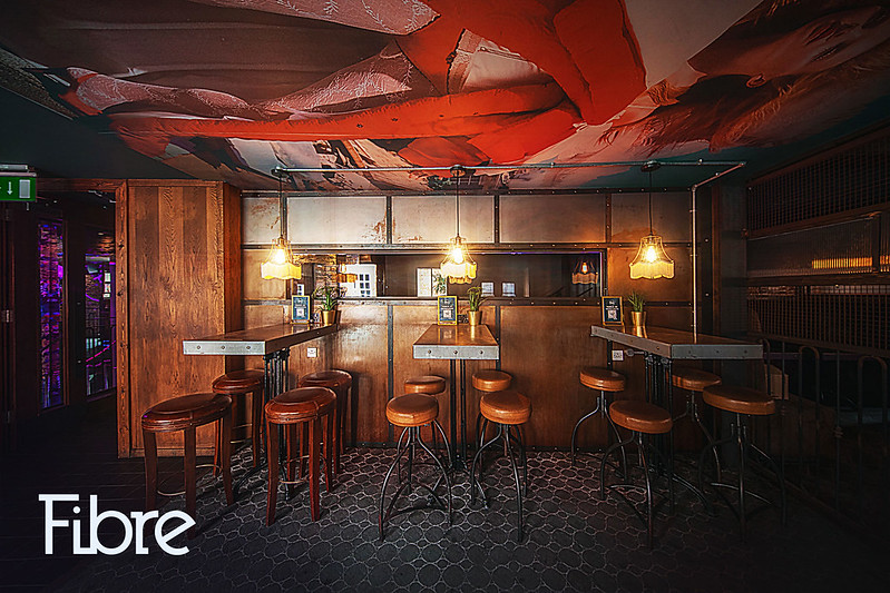 Industrial-chic breakout space with high-top seating for networking events and corporate receptions.