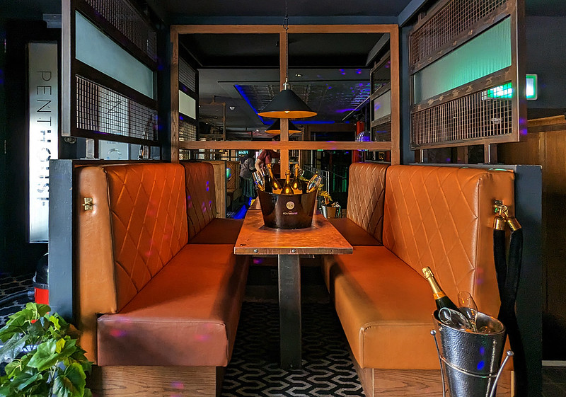 Semi-private VIP booth at Fibre lounge for corporate networking and experiential hospitality.