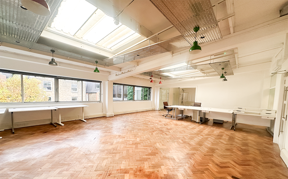 Industrial workspace with herringbone floors, ideal for creative workshops and boutique events.