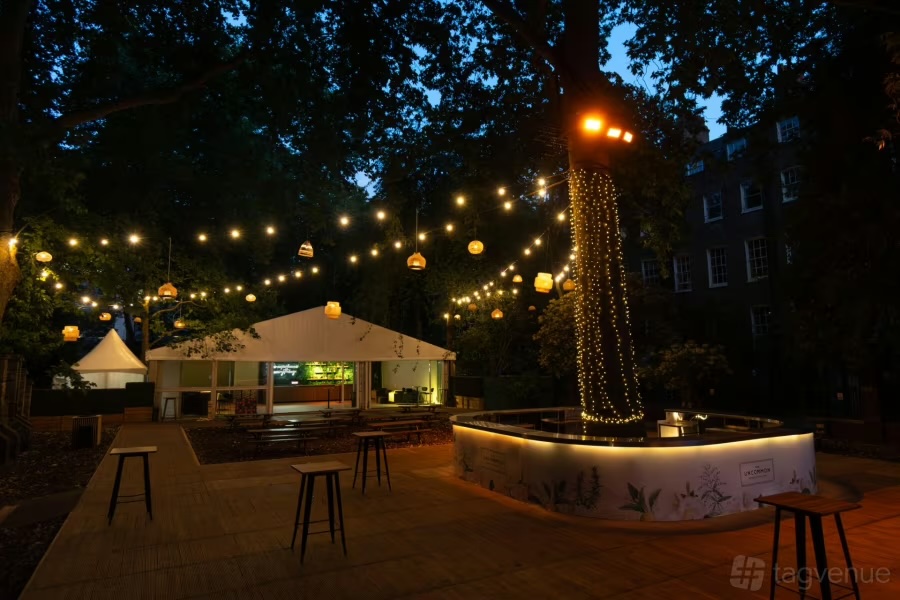 Summer Party at Sunken Garden Bloomsbury with lit tree bar for corporate reception.