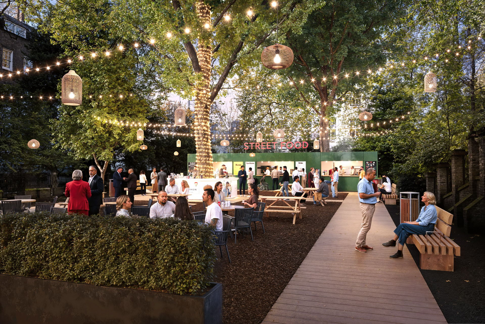 Outdoor networking party at Sunken Garden Bloomsbury with string lights and picnic seating.