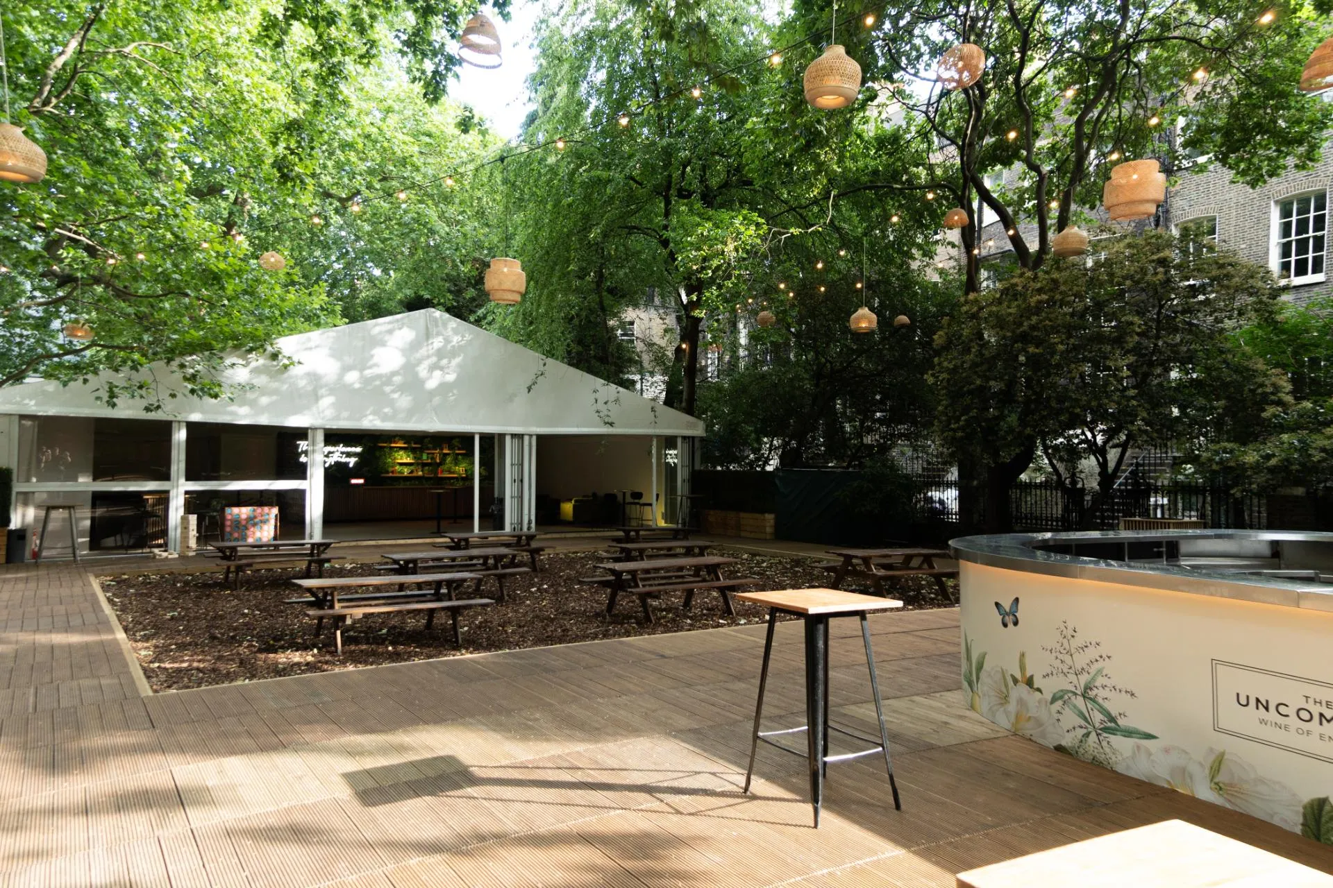 Summer party marquee and picnic seating at The Sunken Garden, Bloomsbury event venue.