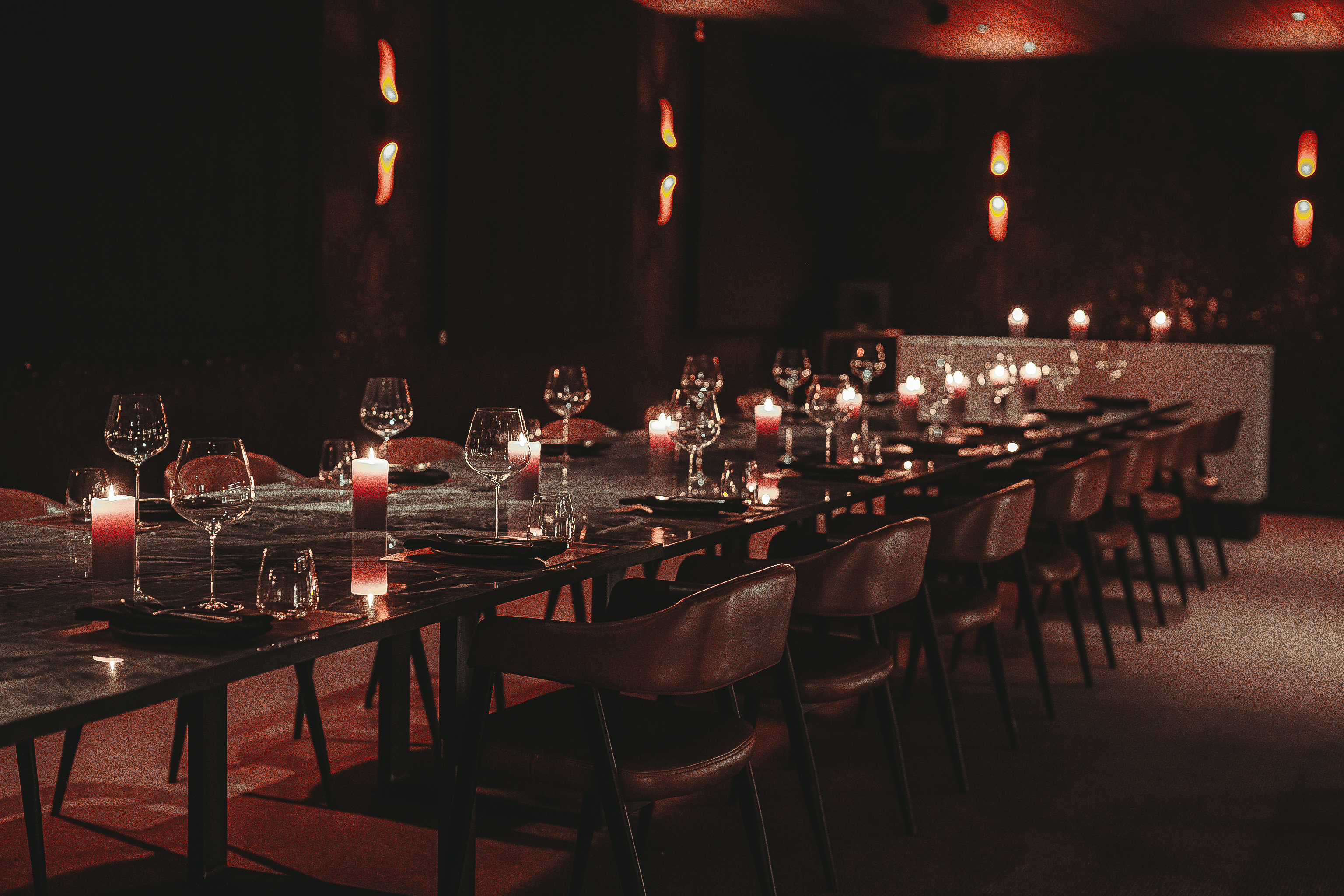 Private dining at Etna in Hora with ambient mood lighting for corporate events and VIP meetings.