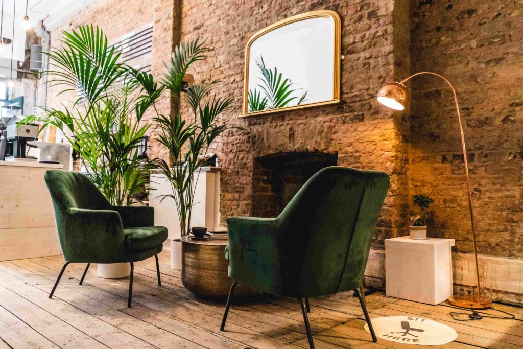 Stylish coworking lounge with green chairs, ideal for networking events and meetings.