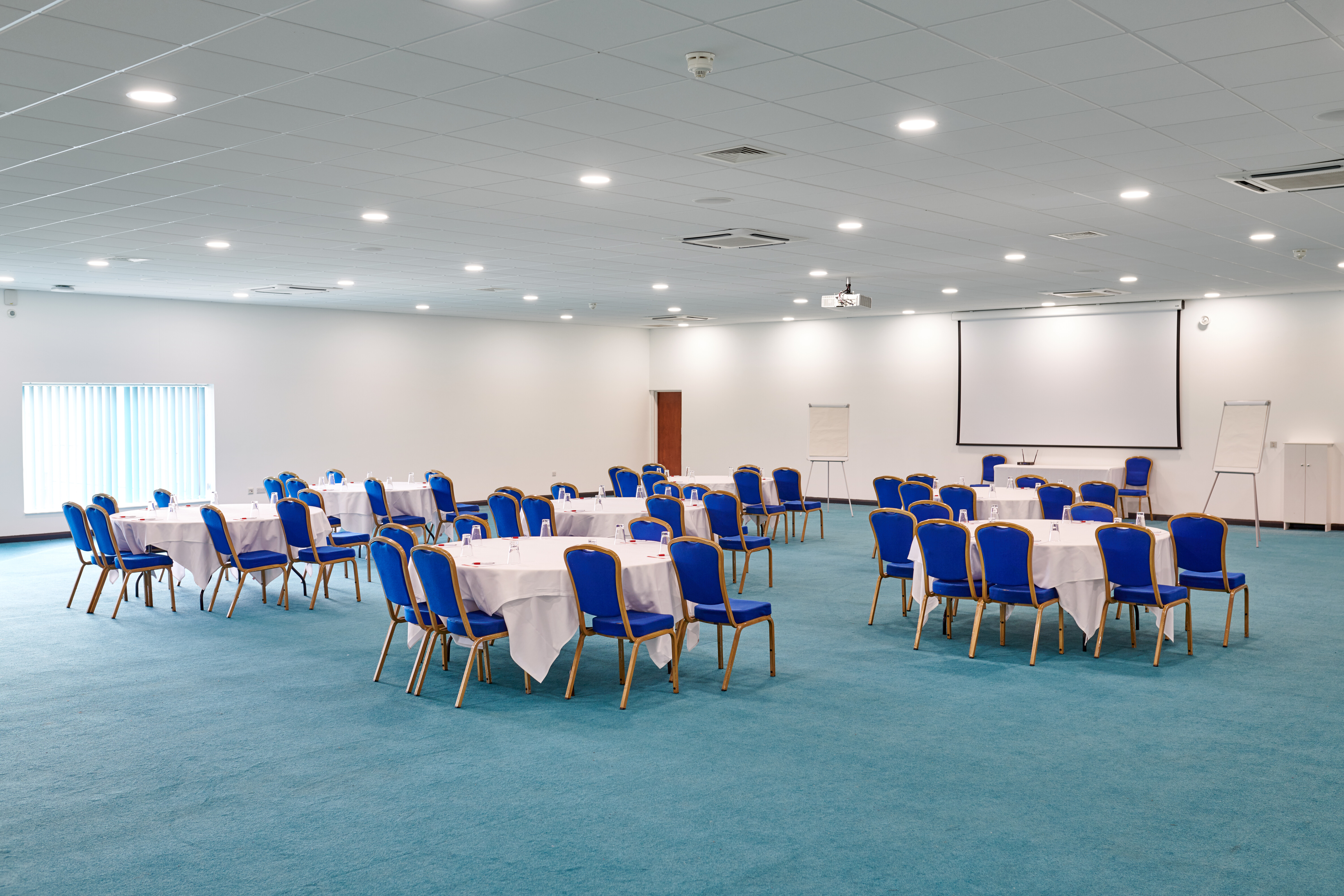 Butlin's Bognor Regis conference room with round tables, ideal for events and presentations.