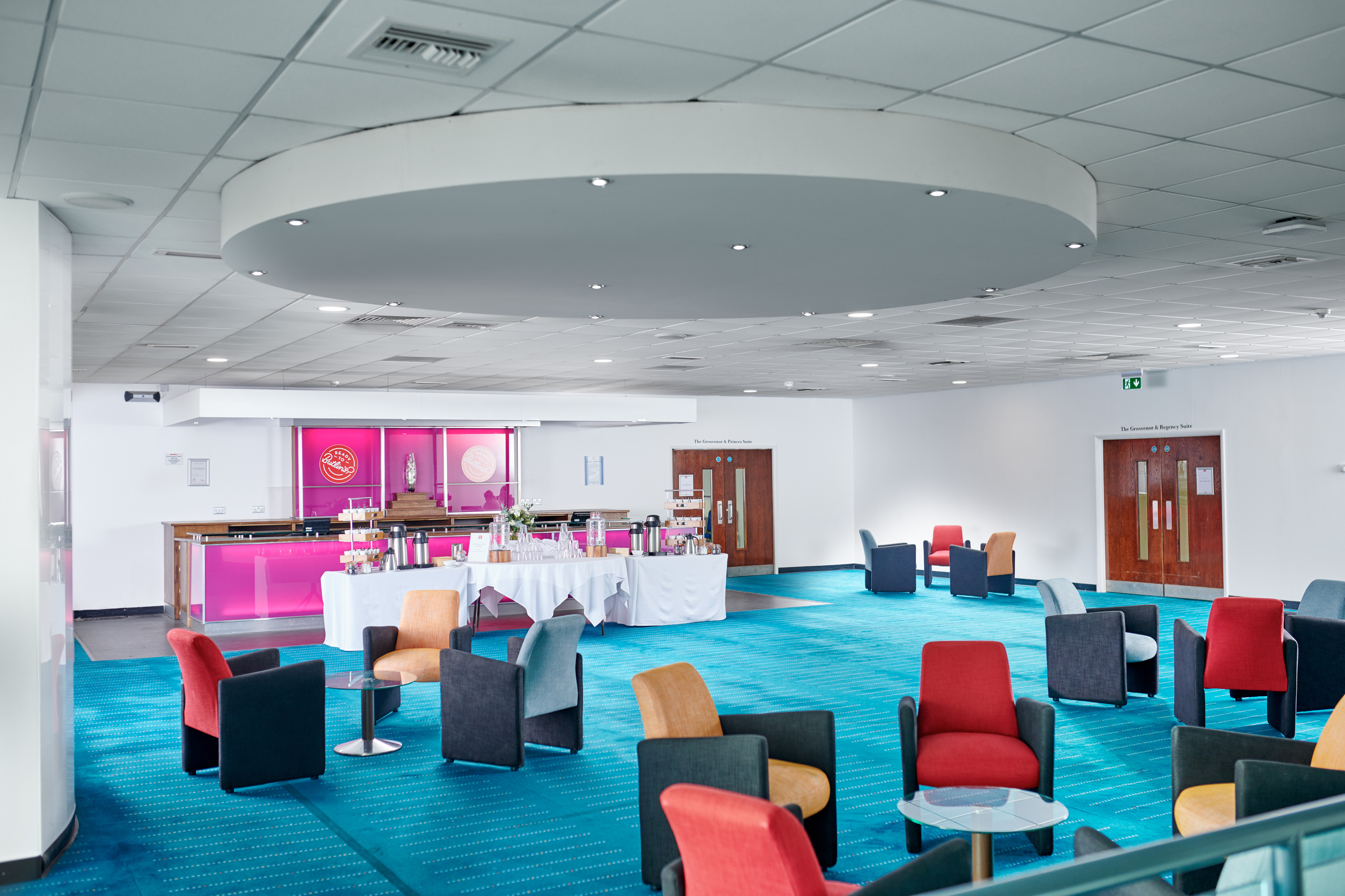 Modern conference centre in Butlin's Bognor Regis, vibrant blue carpet, ideal for events.