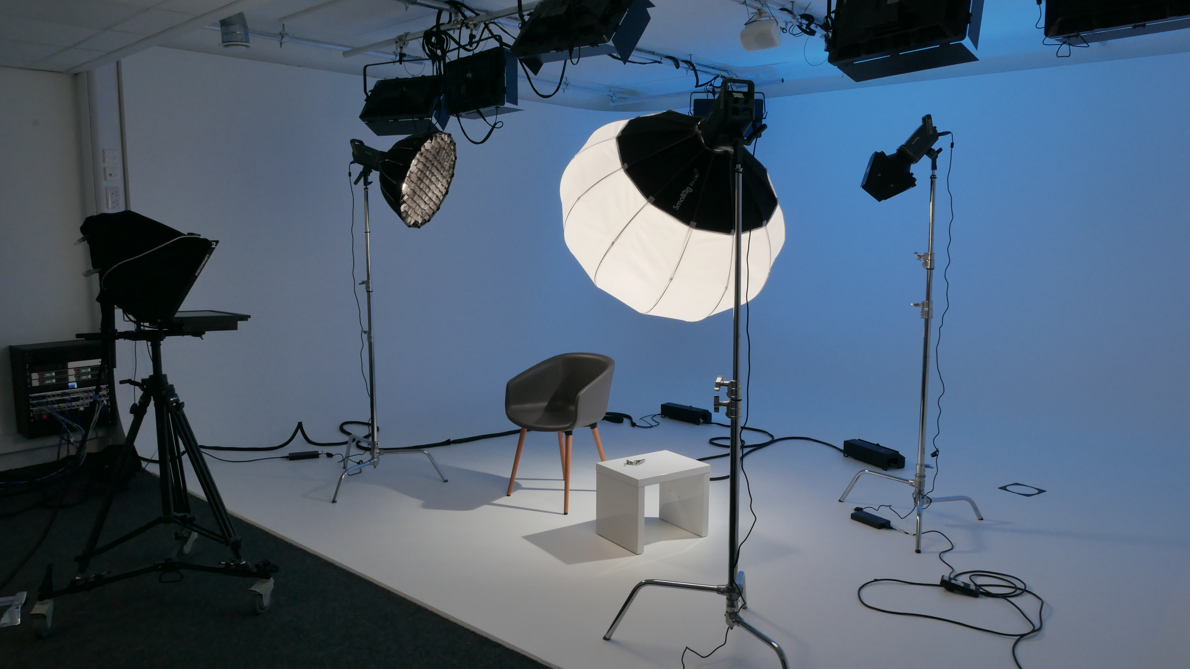 Professional video shoot setup with softbox lighting and minimal background