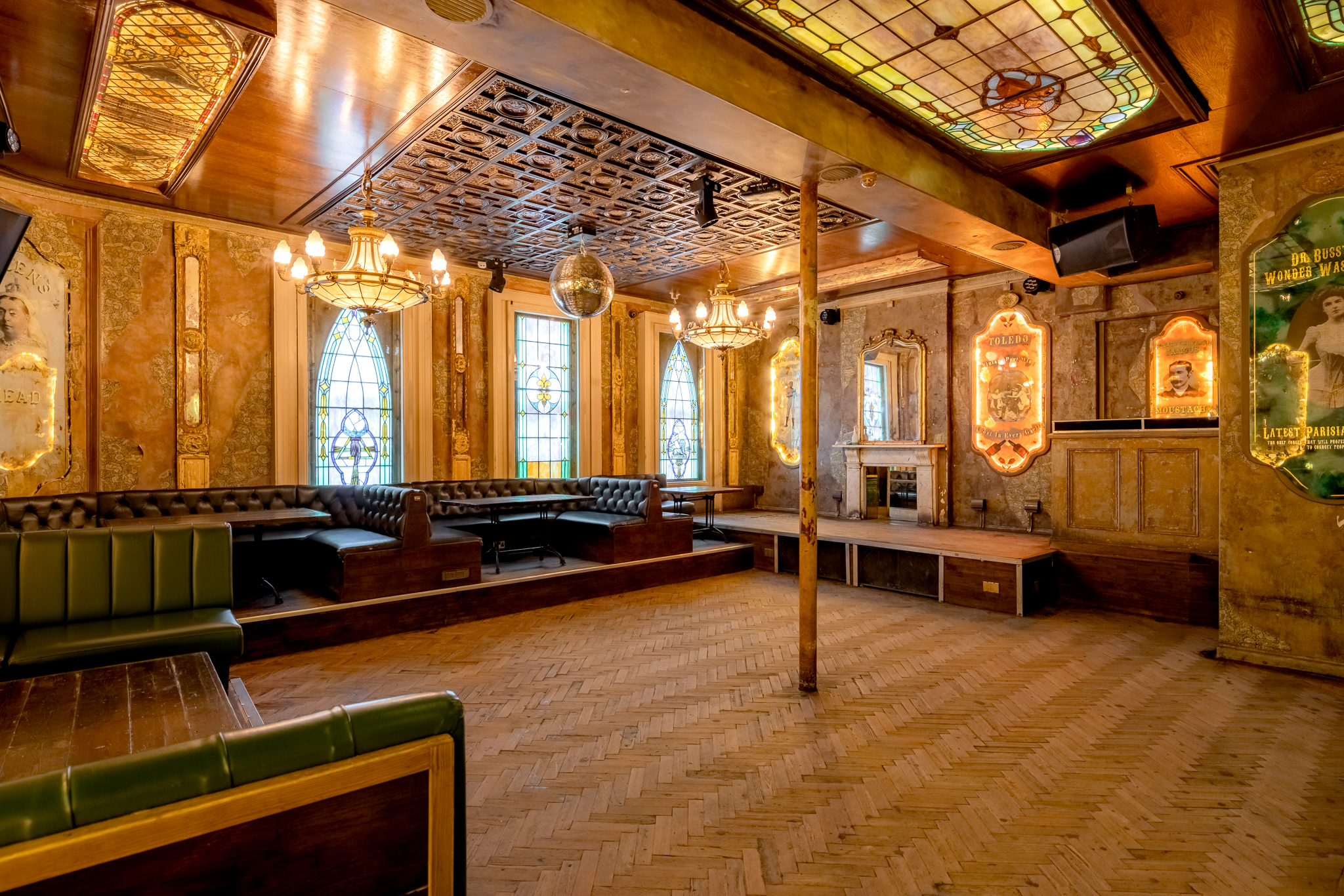 Stylish event space with stained glass windows at The Old Queen's Head for gatherings.