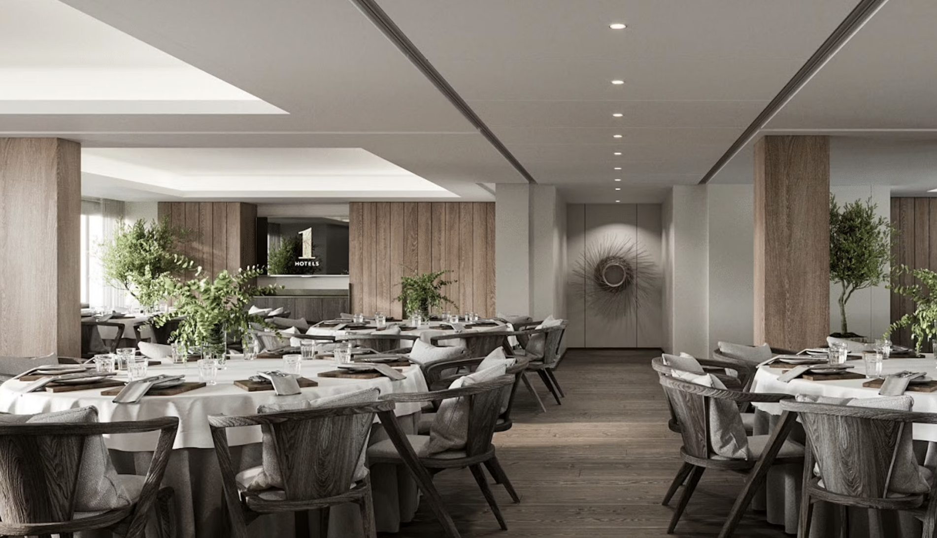 Elegant event space at 1 Hotel Mayfair, featuring round tables and natural light.