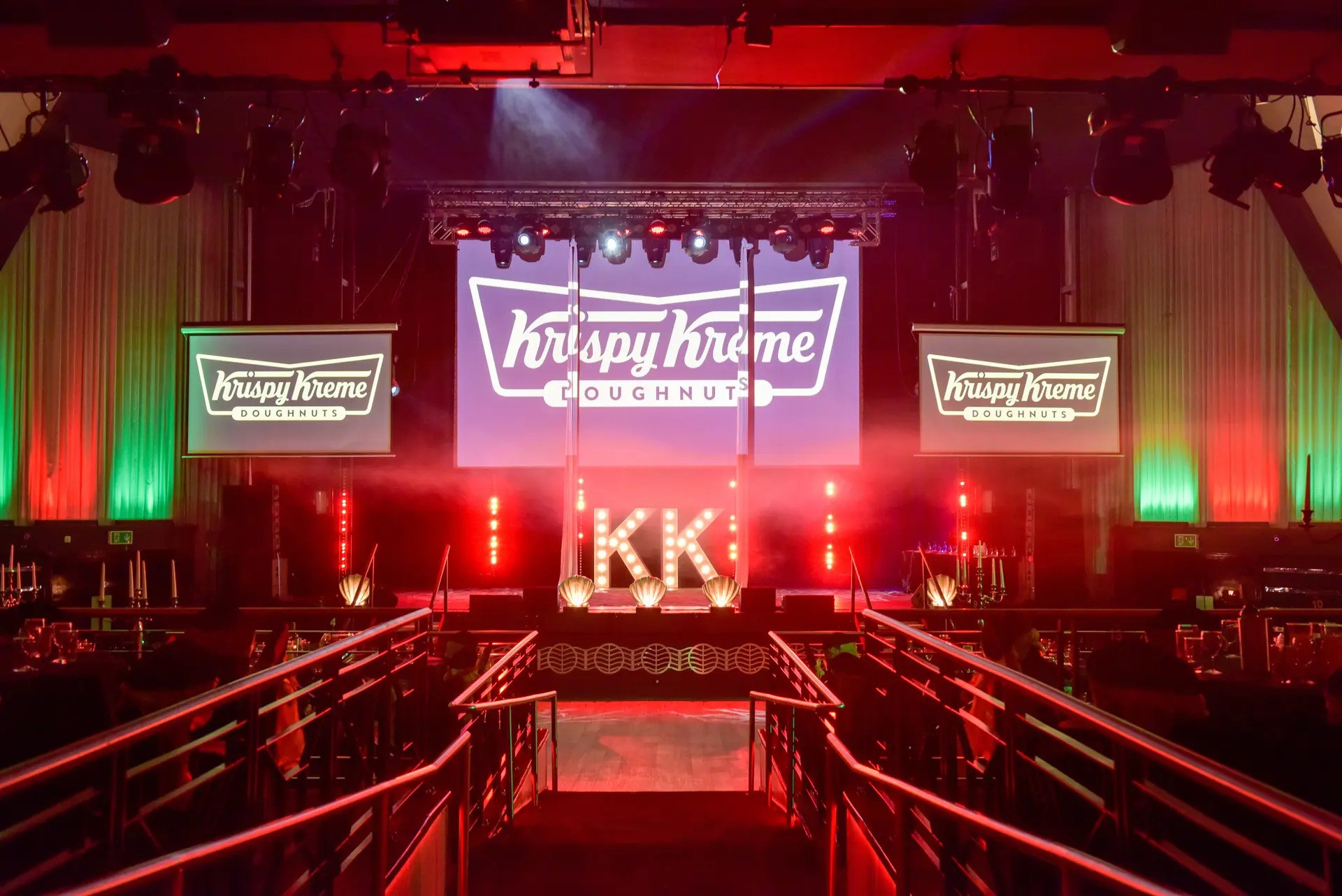 Krispy Kreme-themed event space with vibrant lighting and branding in Athena.