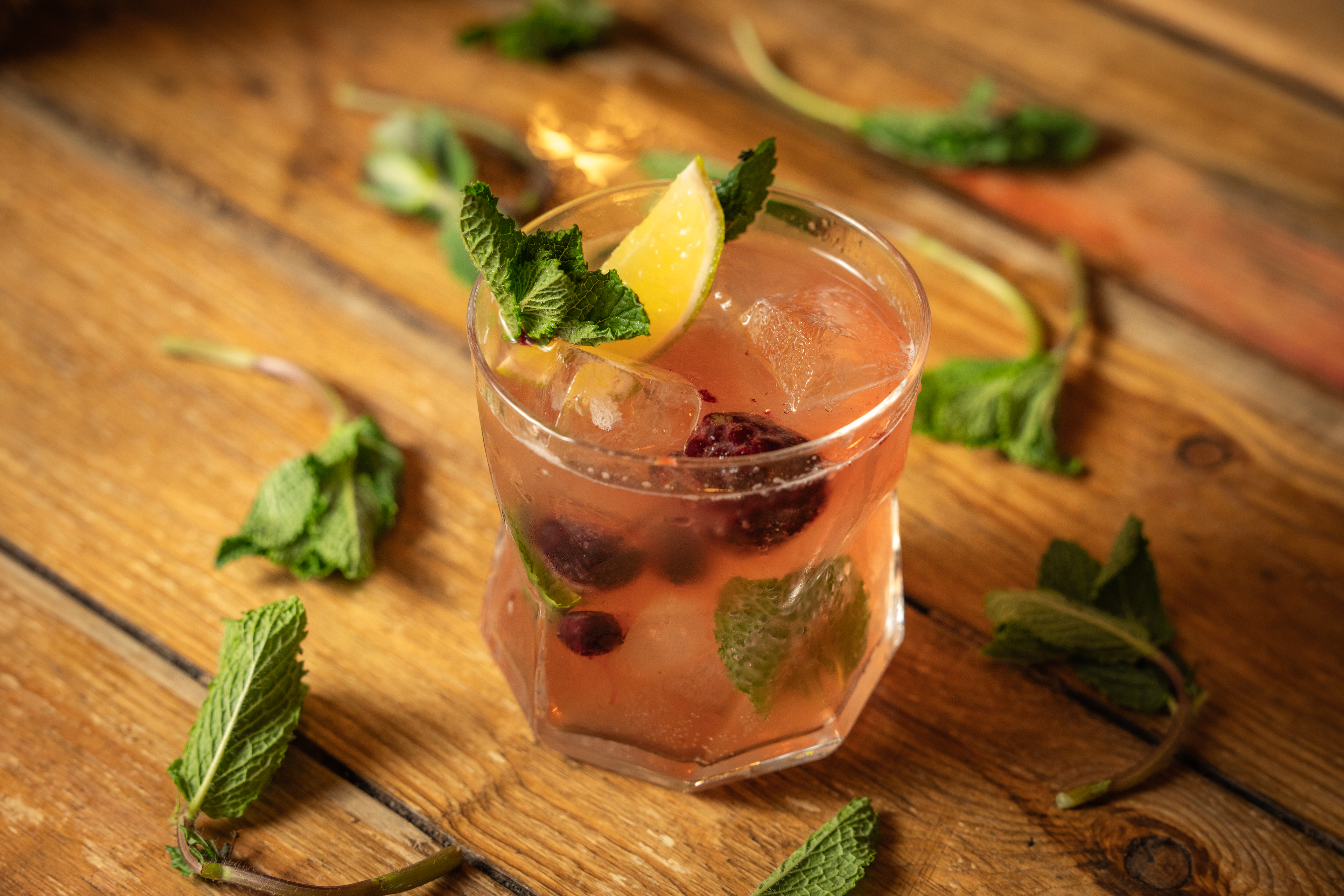 Refreshing cocktail with mint and lemon at Bird of Paradise Bar, perfect for summer events.