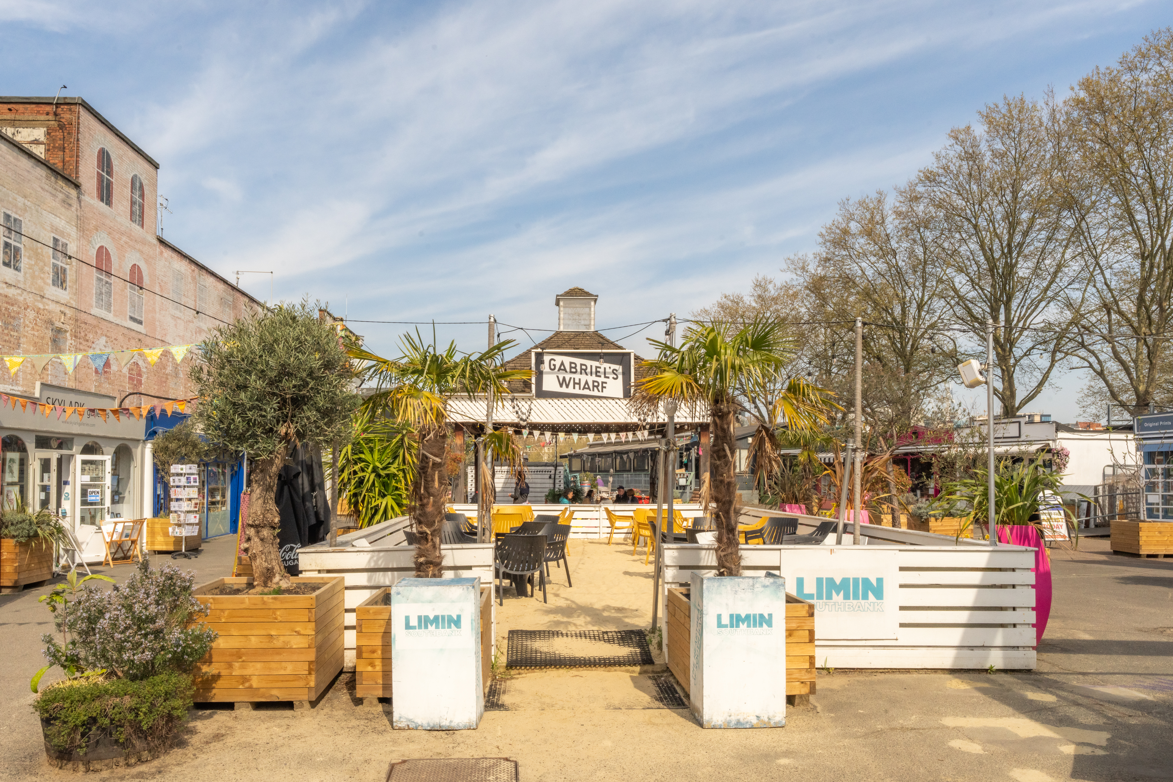 Vibrant outdoor venue at Limin Southbank for events and workshops with palm trees.