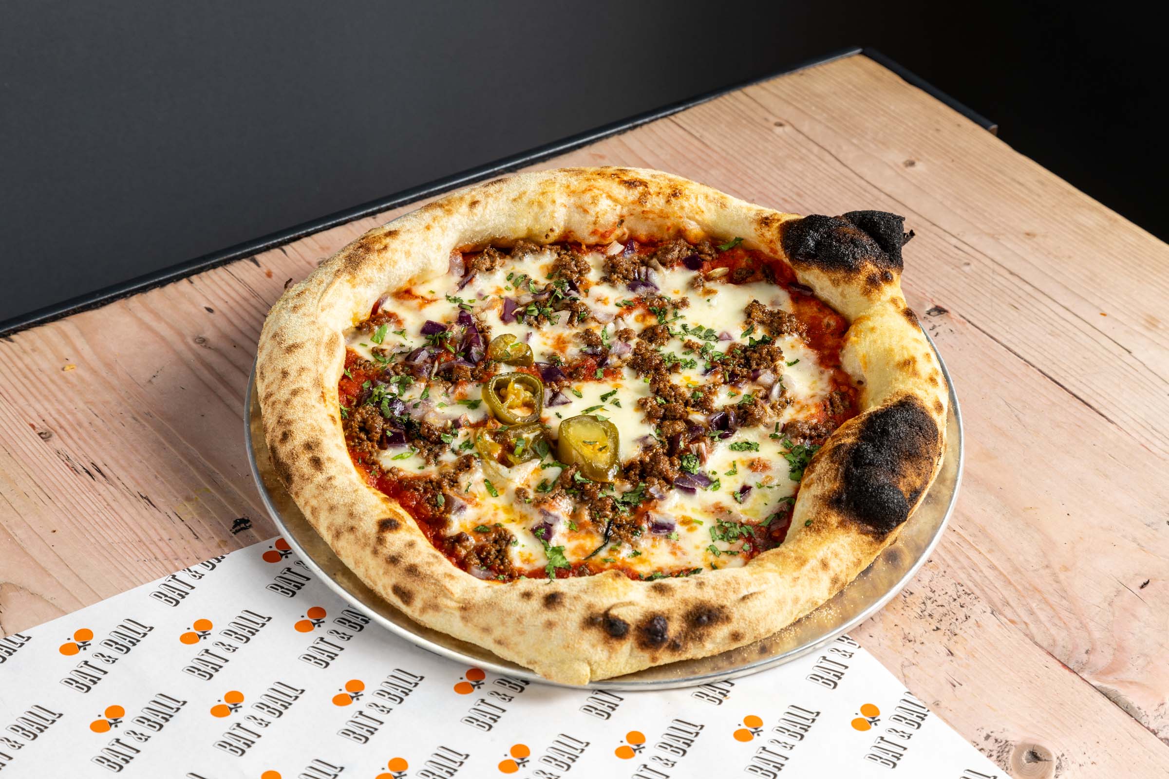 Artisan pizza with golden crust at Ping-Pong Parlour, ideal for events and gatherings.