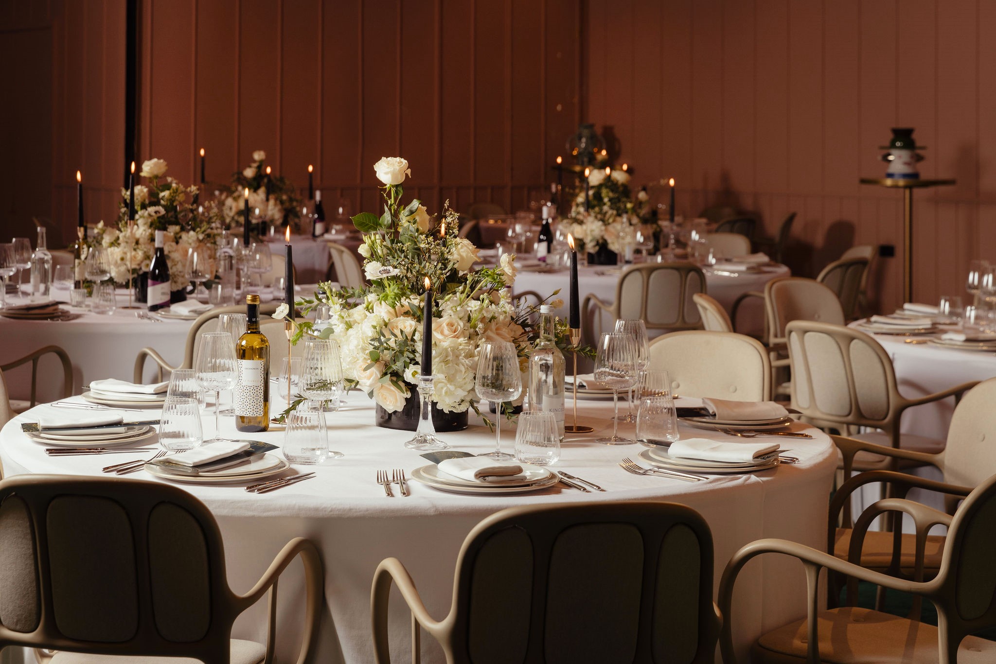 Elegant dining setup with floral centerpieces for weddings and corporate events.