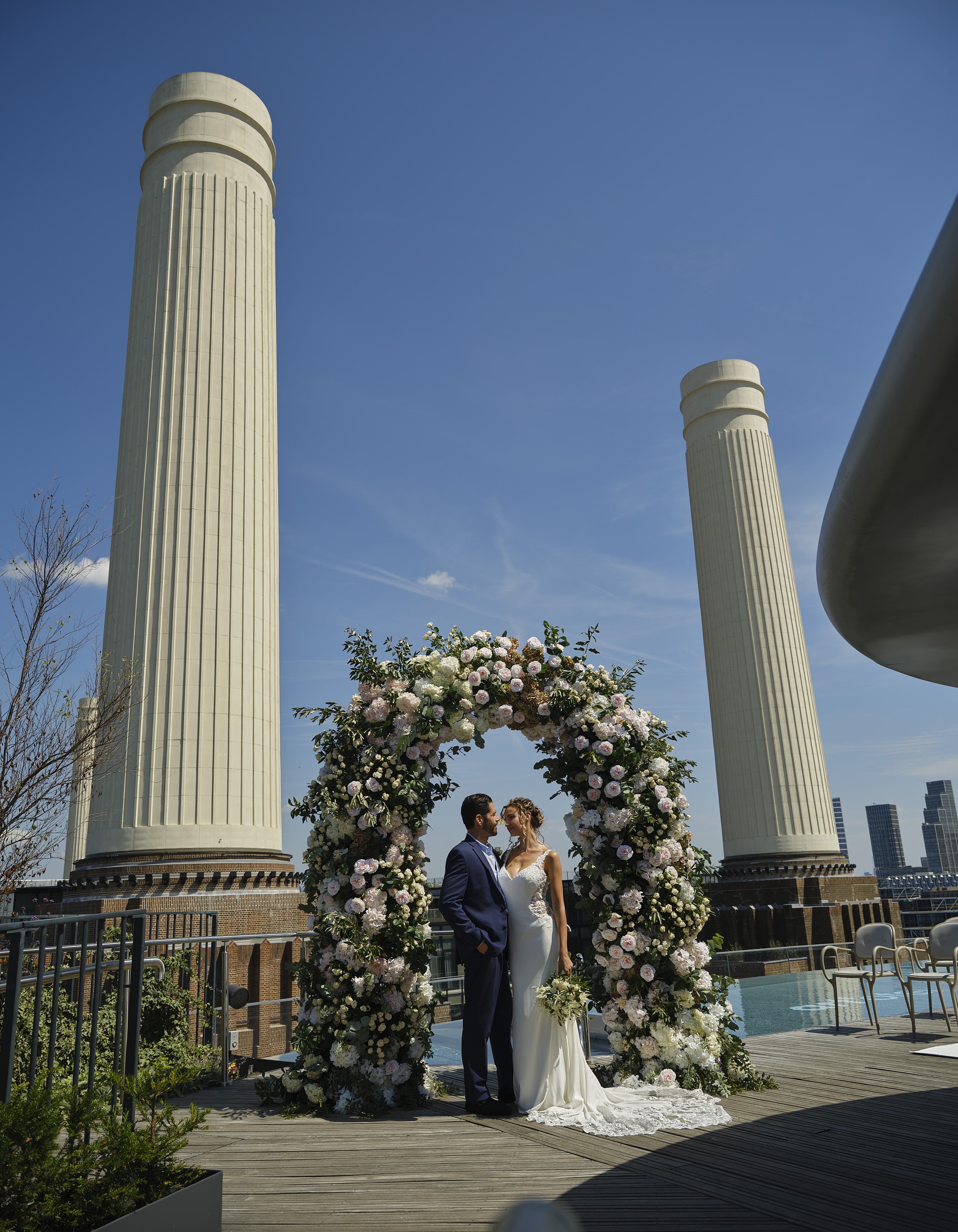 Outdoor wedding at JOIA Rooftop, floral arch, romantic venue in London.
