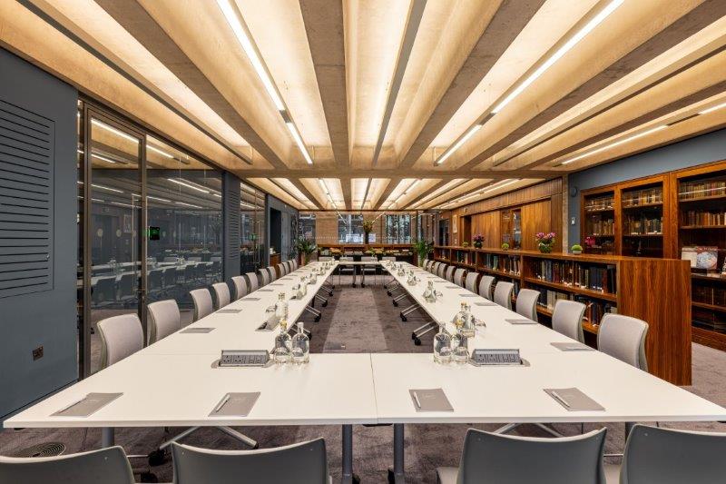 Modern conference room with sleek table, ideal for professional meetings and events.