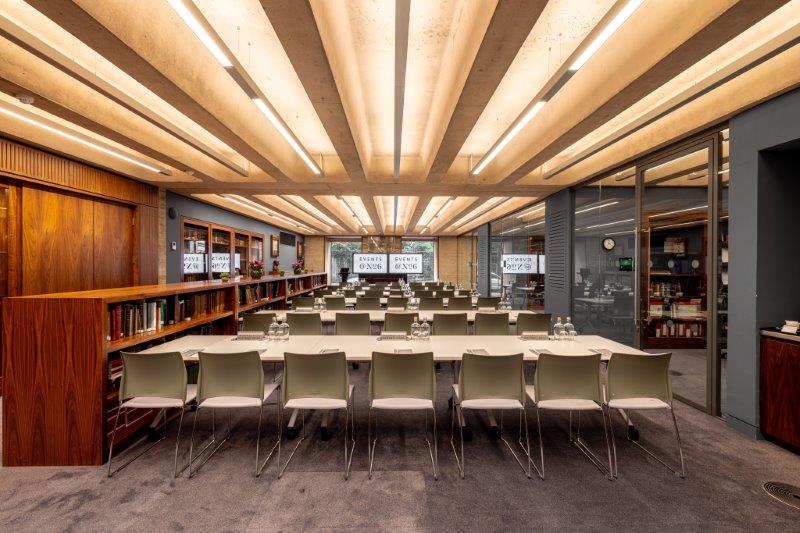Modern library meeting room with natural light, perfect for workshops and presentations.