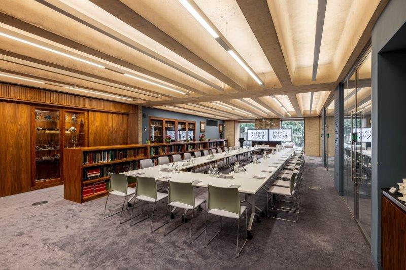 Modern conference room with long table, ideal for corporate meetings and workshops.