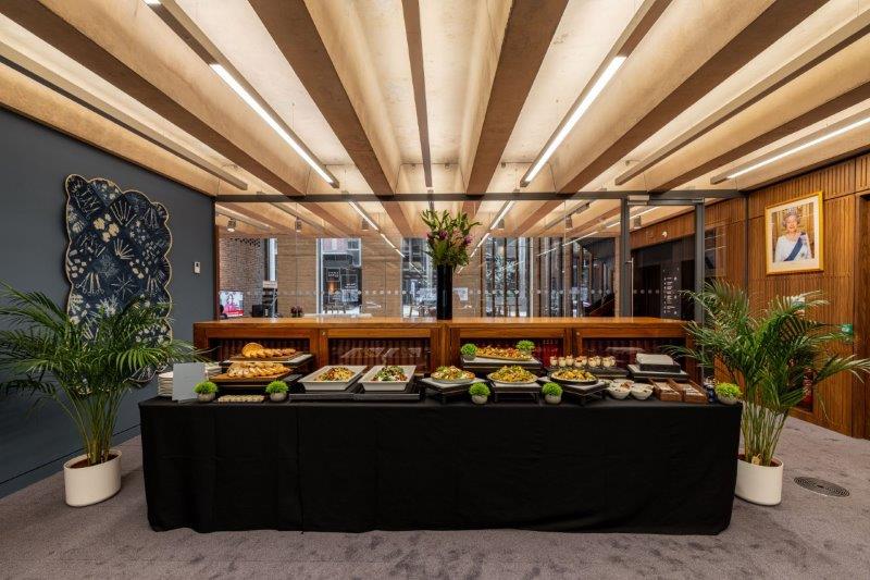 Catering setup in Library Meeting Room for networking event with stylish decor.
