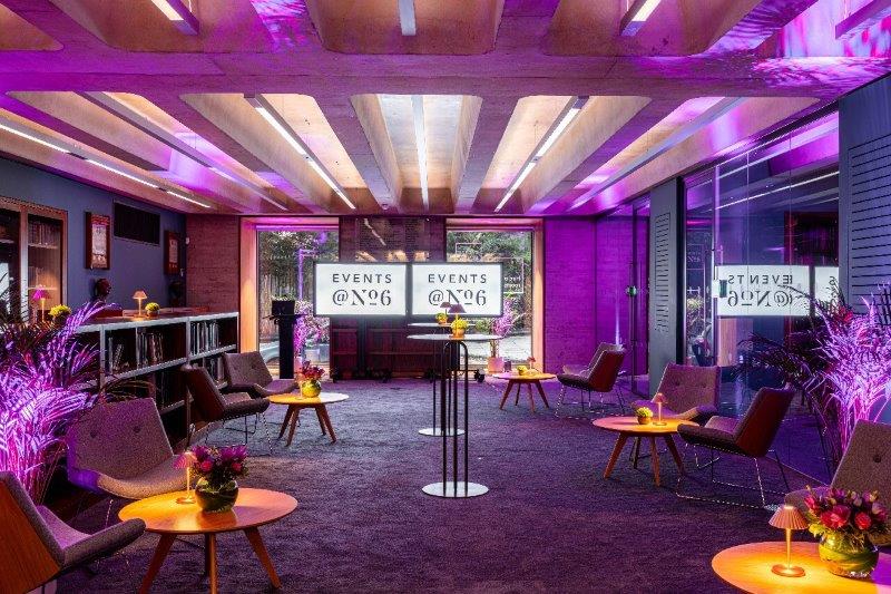 Stylish Library Meeting Room with purple lighting for modern events and networking.