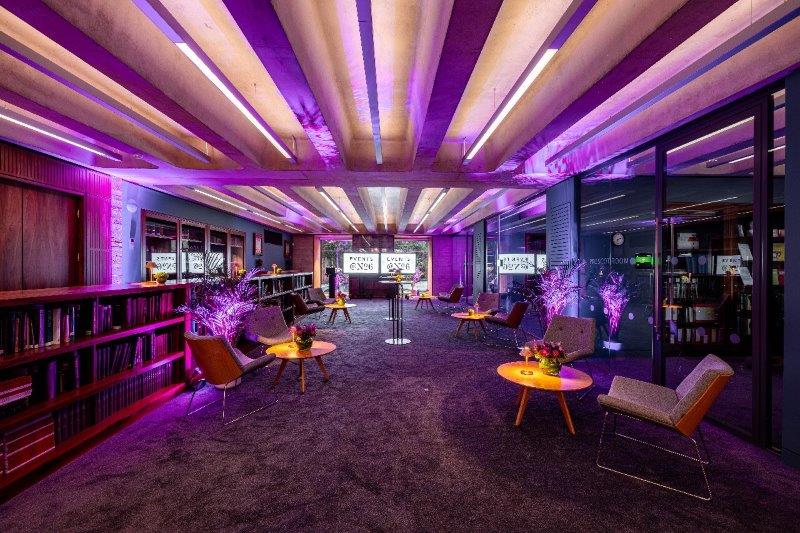 Modern Library Meeting Room with purple lighting for versatile events and gatherings.