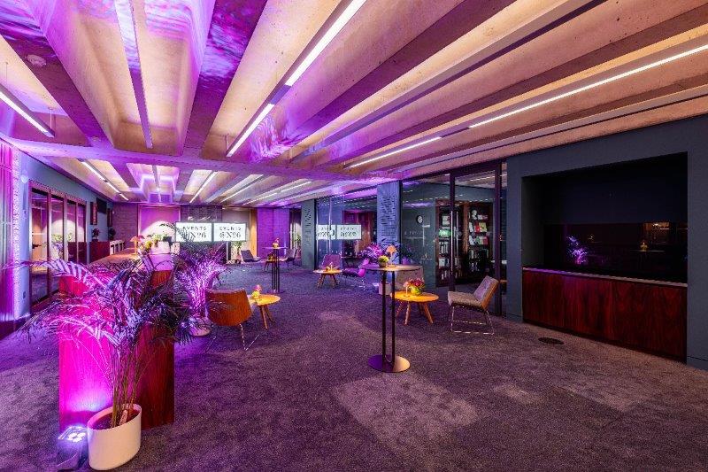 Modern Library Meeting Room with purple lighting for versatile events and presentations.