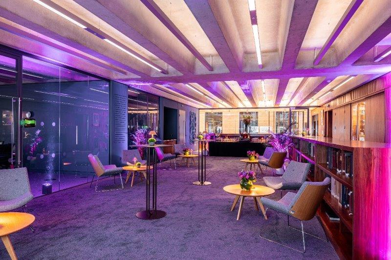 Modern Library Meeting Room with purple lighting for networking and social events.