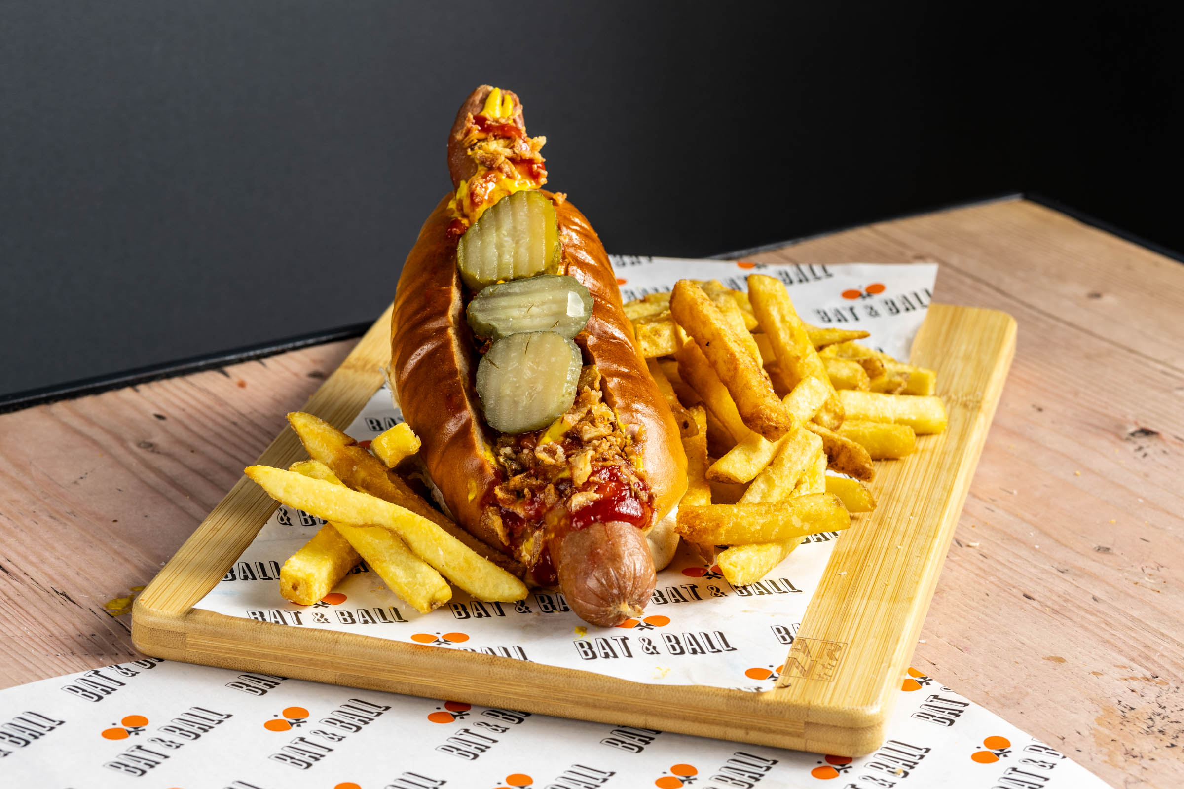 Creative hot dog with fries at Players Lounge, ideal for casual catering events.