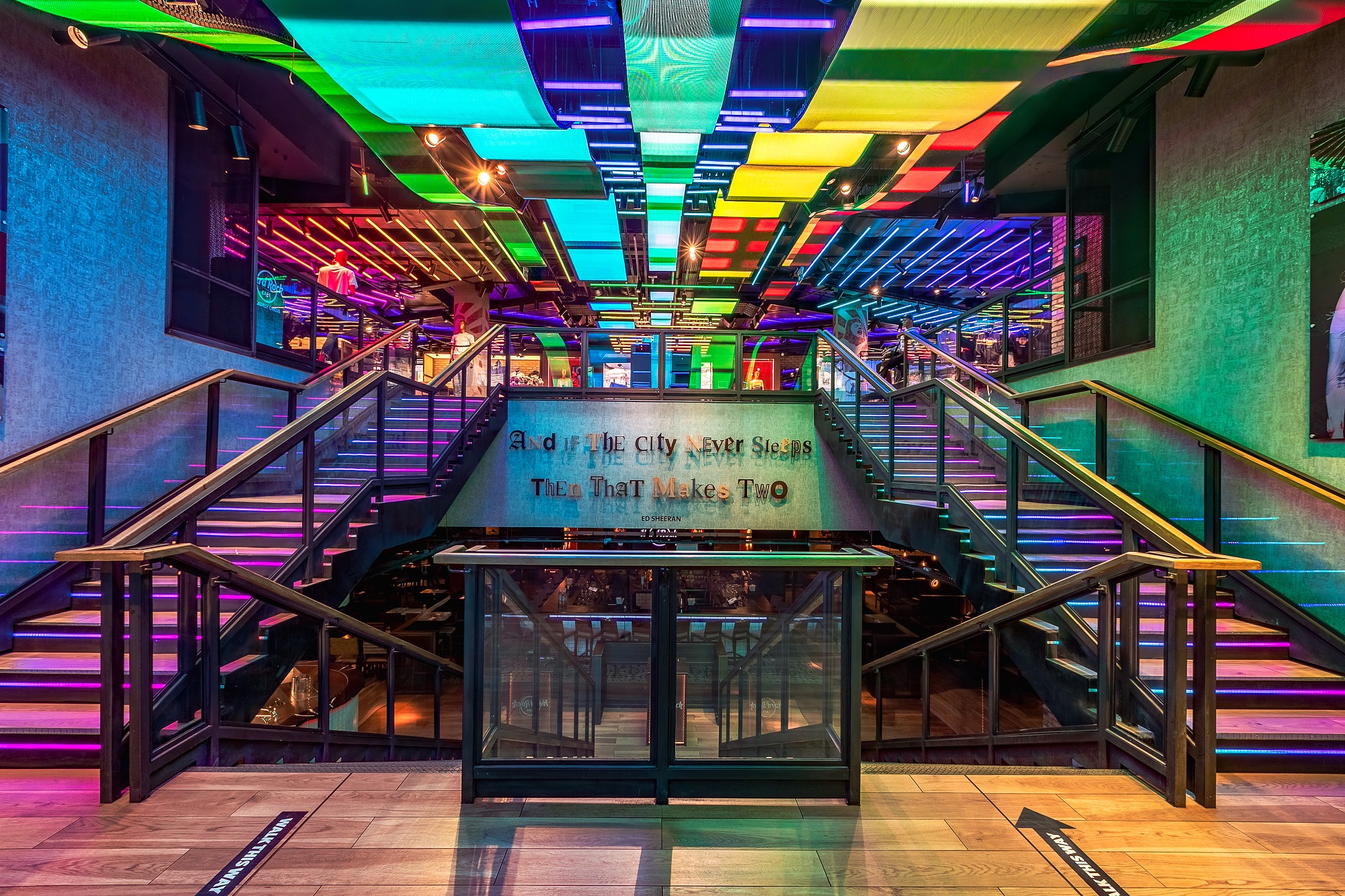 Vibrant Hard Rock Cafe Piccadilly Circus event space with colorful lighting and staircase.
