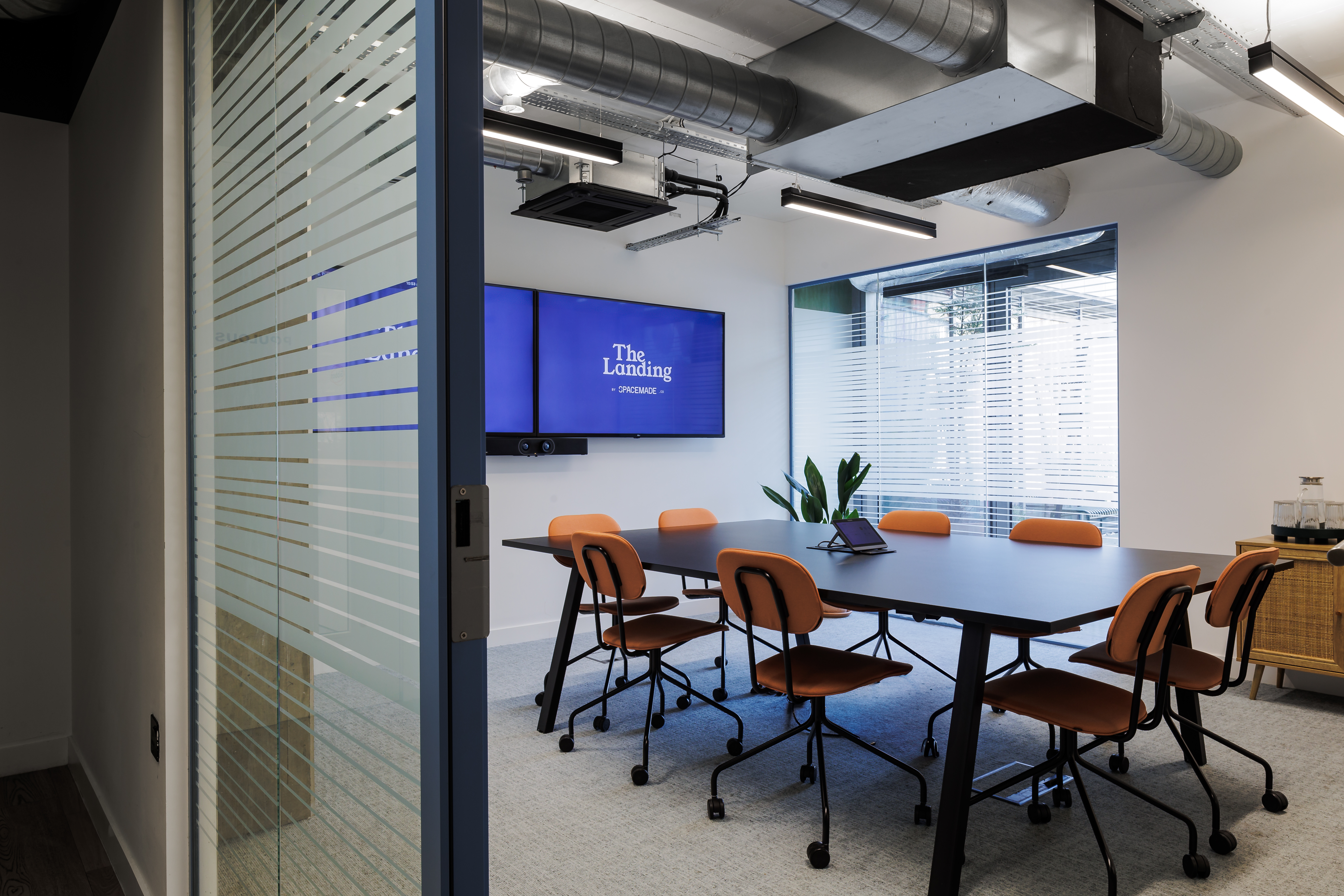 Modern Ackerley Meeting Room with large conference table for workshops and client meetings.