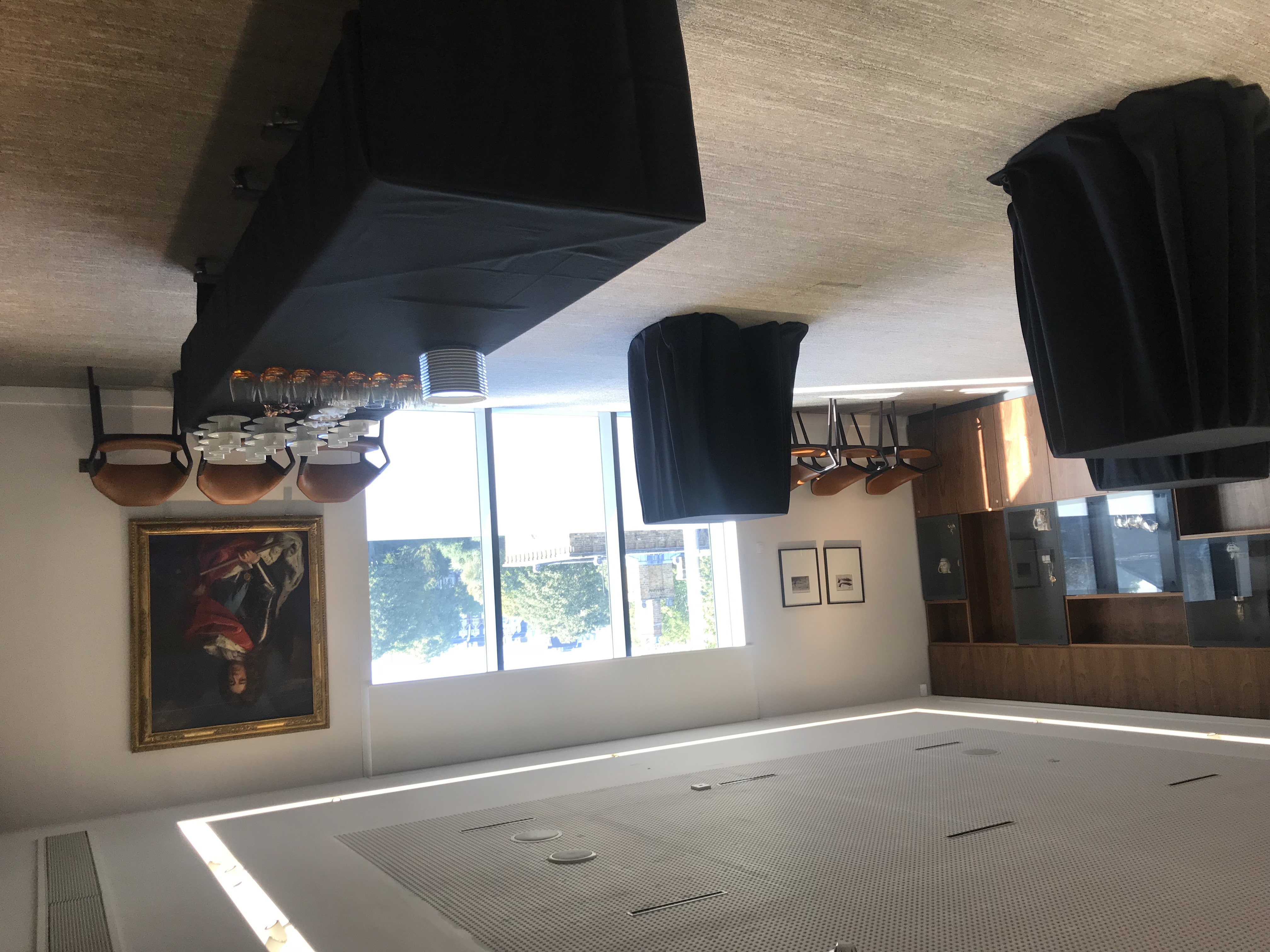 Elegant boardroom with high-top tables for corporate meetings and networking events.