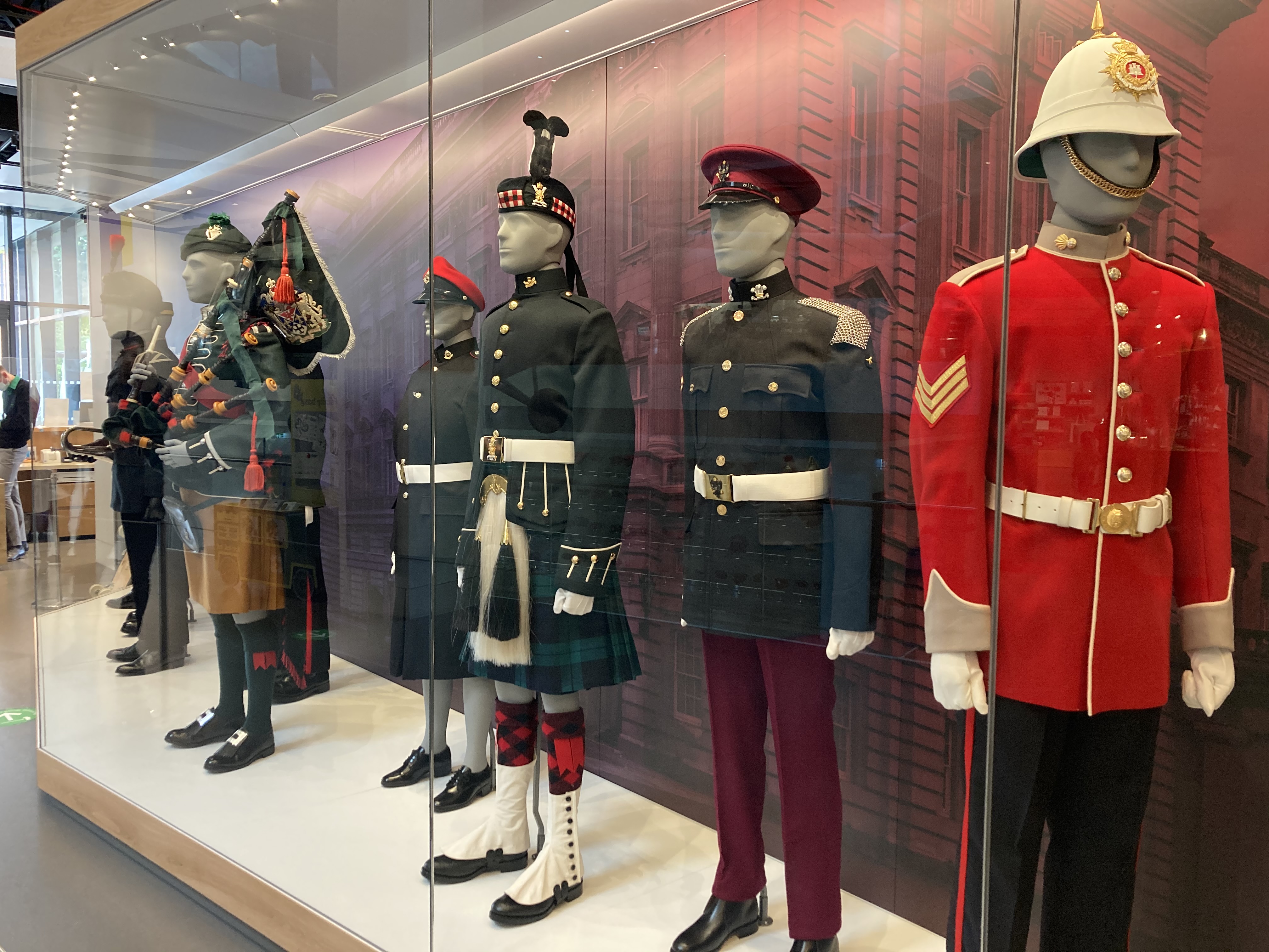 "National Army Museum boardroom display of historical military uniforms for themed events."