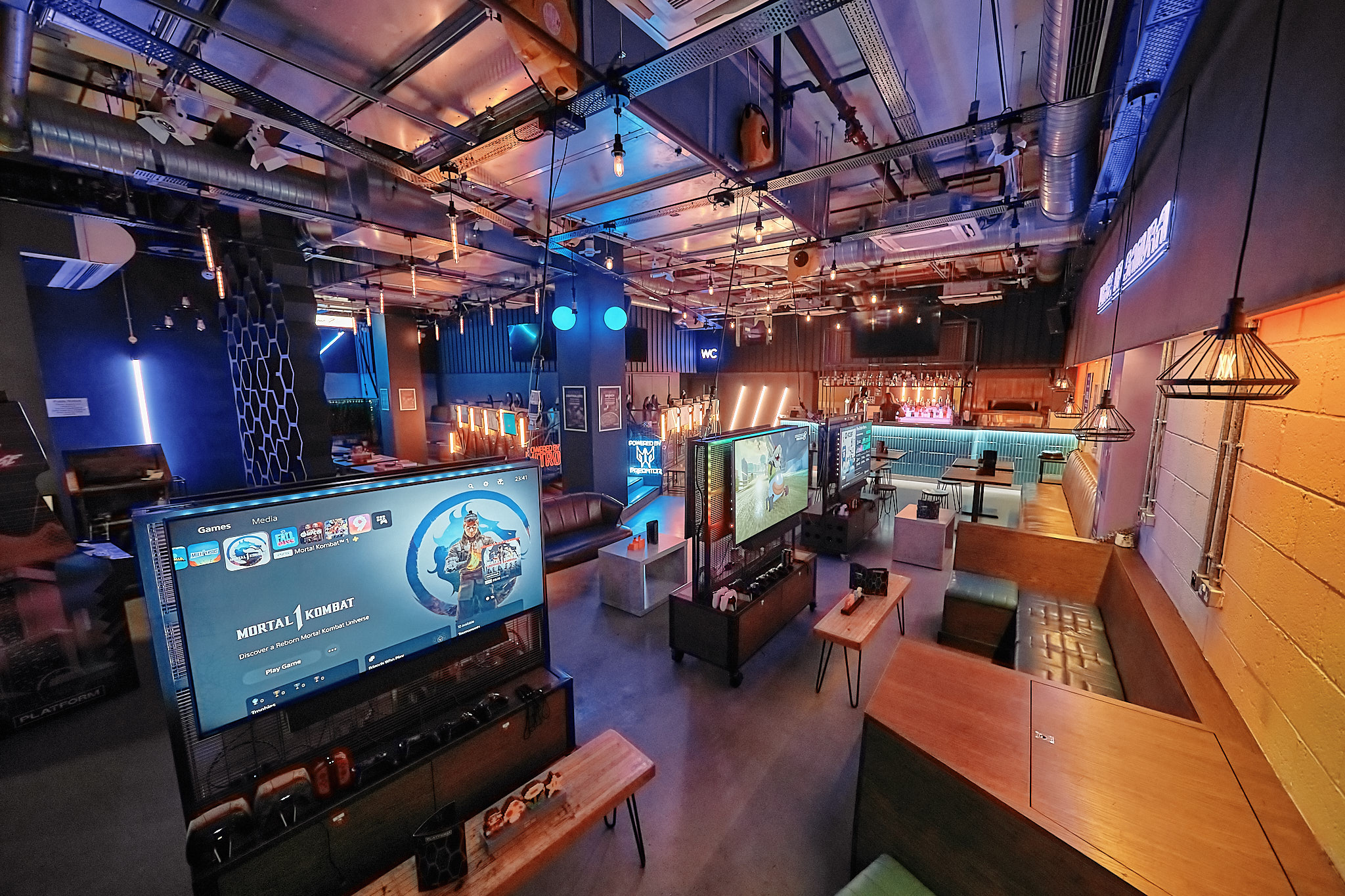 Modern gaming event venue with vibrant lighting, ideal for corporate gatherings.