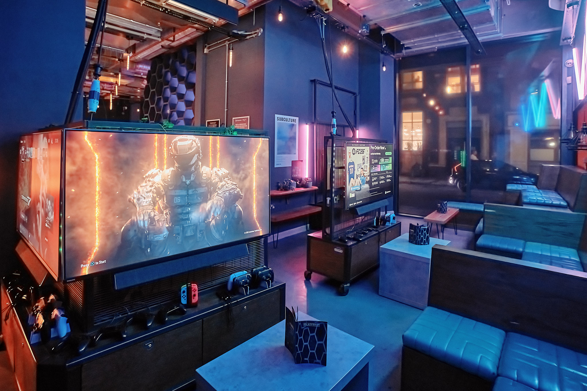 Modern gaming venue with large screens, ideal for tournaments and entertainment events.