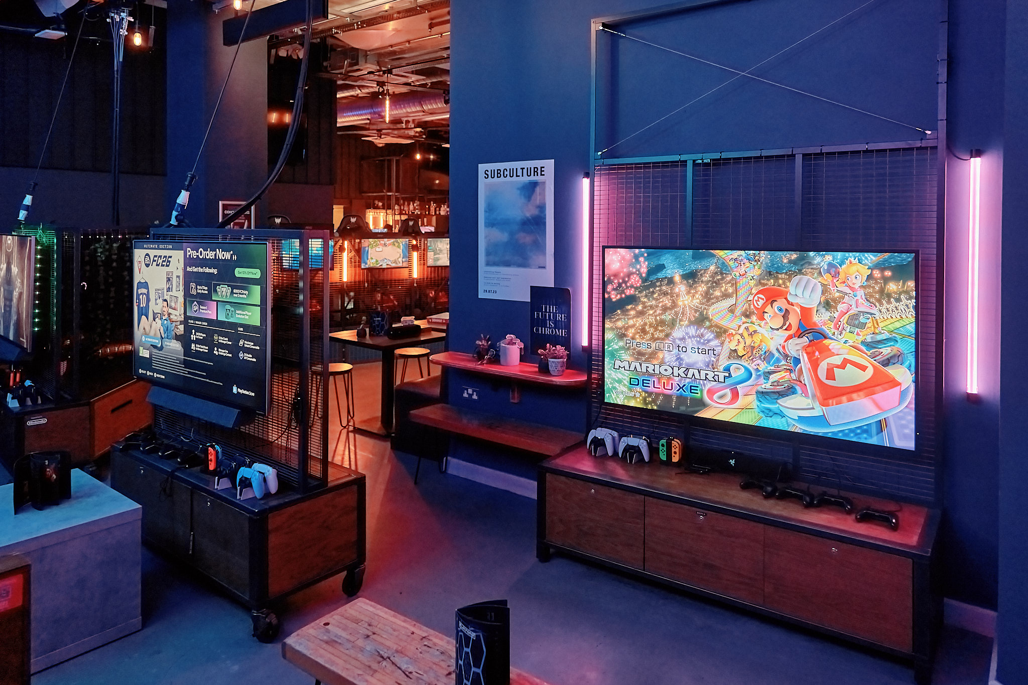 Vibrant gaming lounge with dual screens for corporate events and team-building activities.
