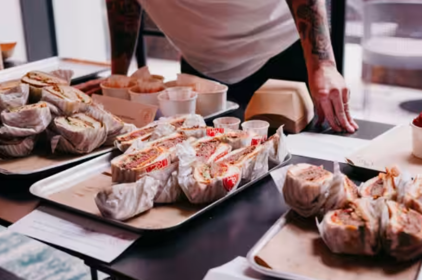 Catering setup at Qube Bar and Lounge, featuring gourmet sandwiches for events.