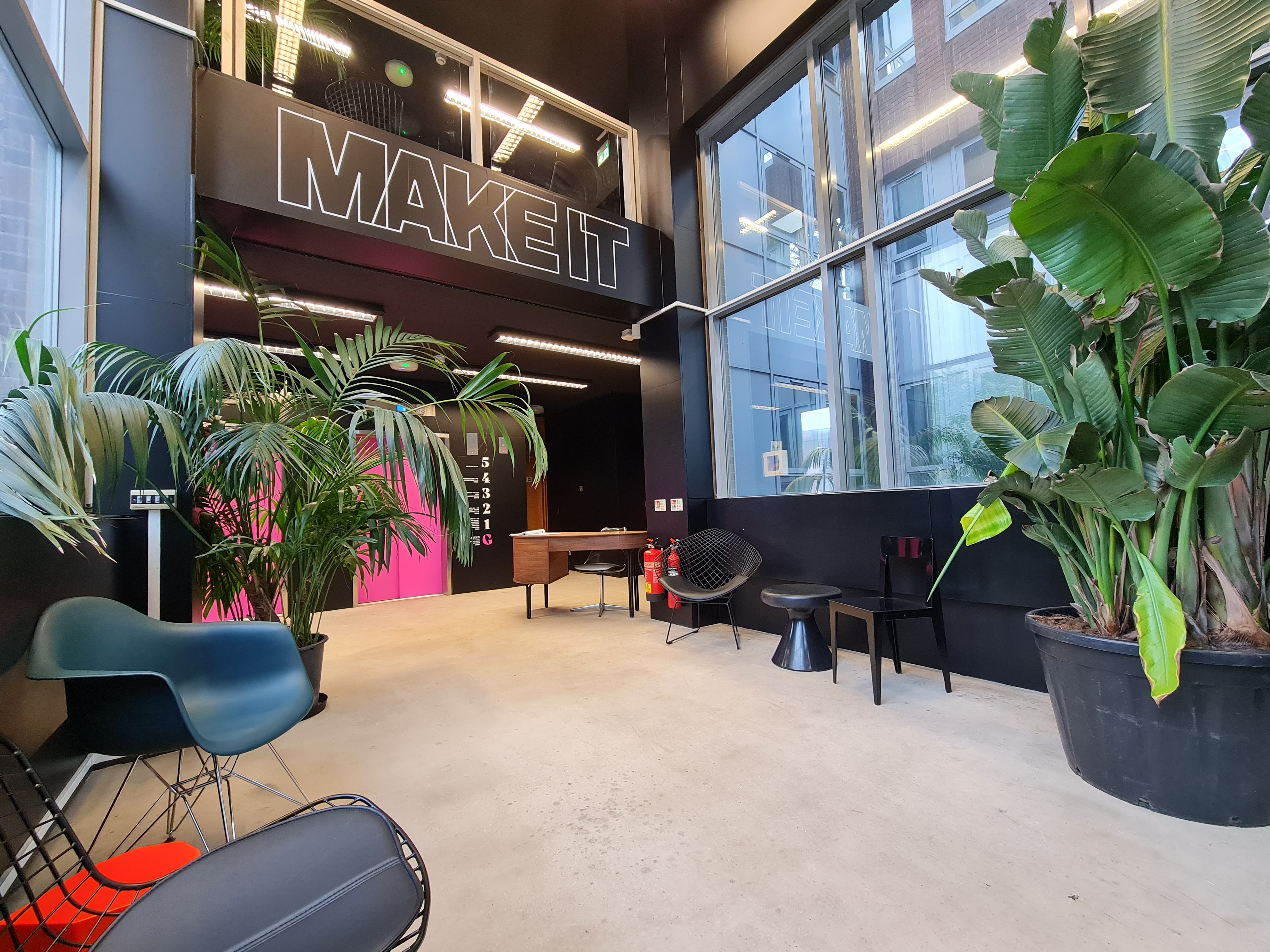Modern event space at MAKE IT Barking with bold mural, perfect for networking and meetings.