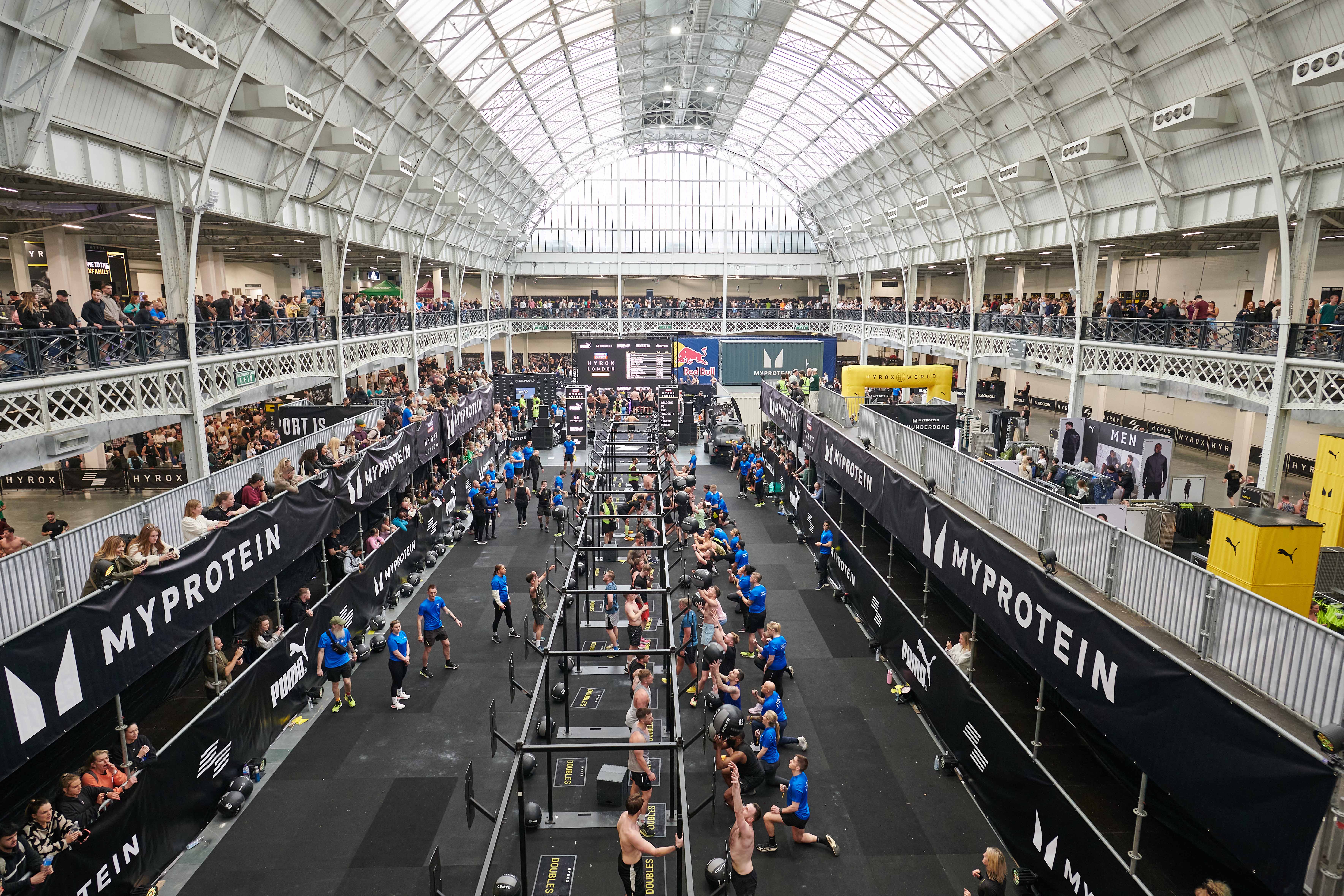 National Hall Olympia fitness competition with high ceilings and vibrant atmosphere.