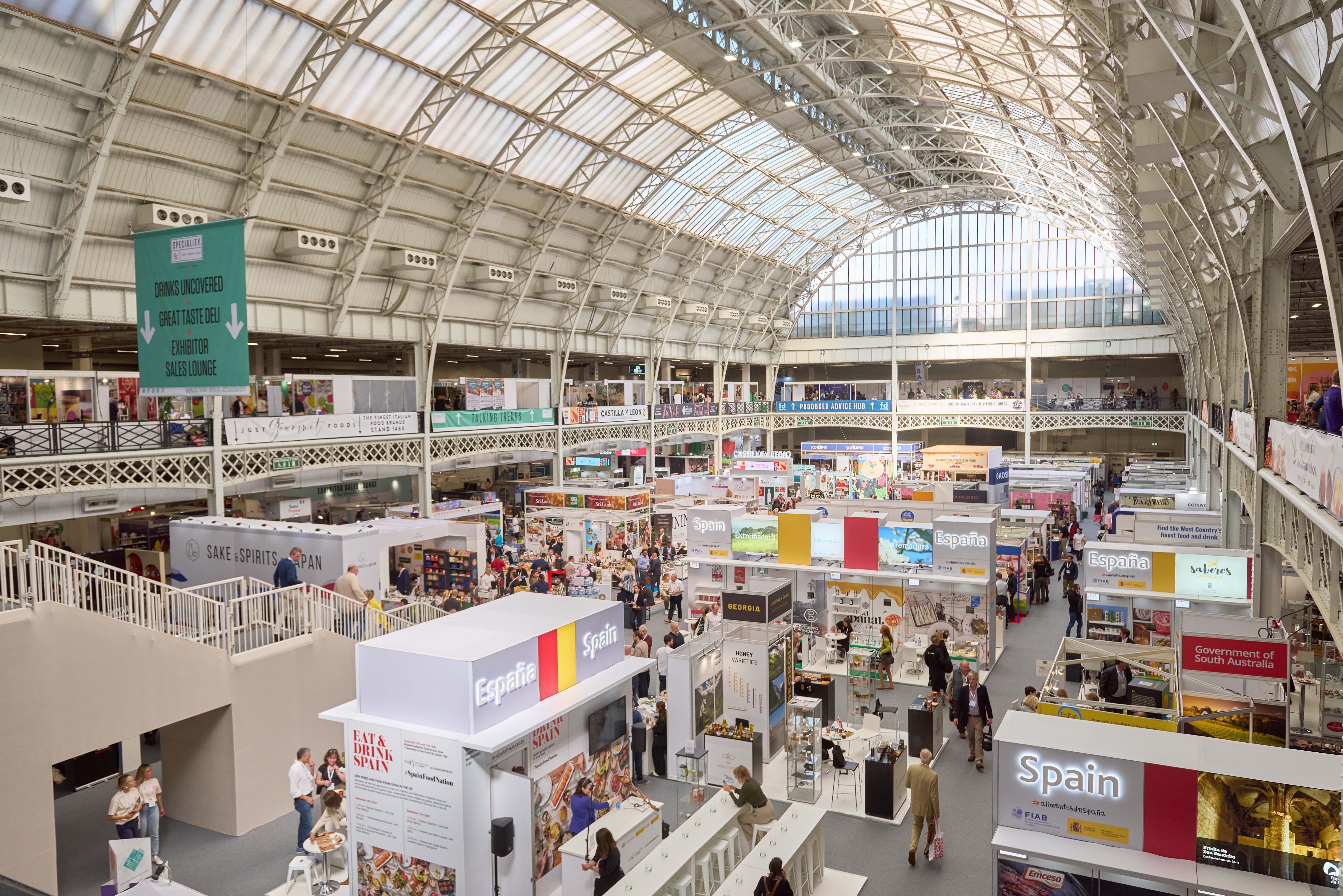 National Hall in Olympia, vibrant exhibition booths, networking event.