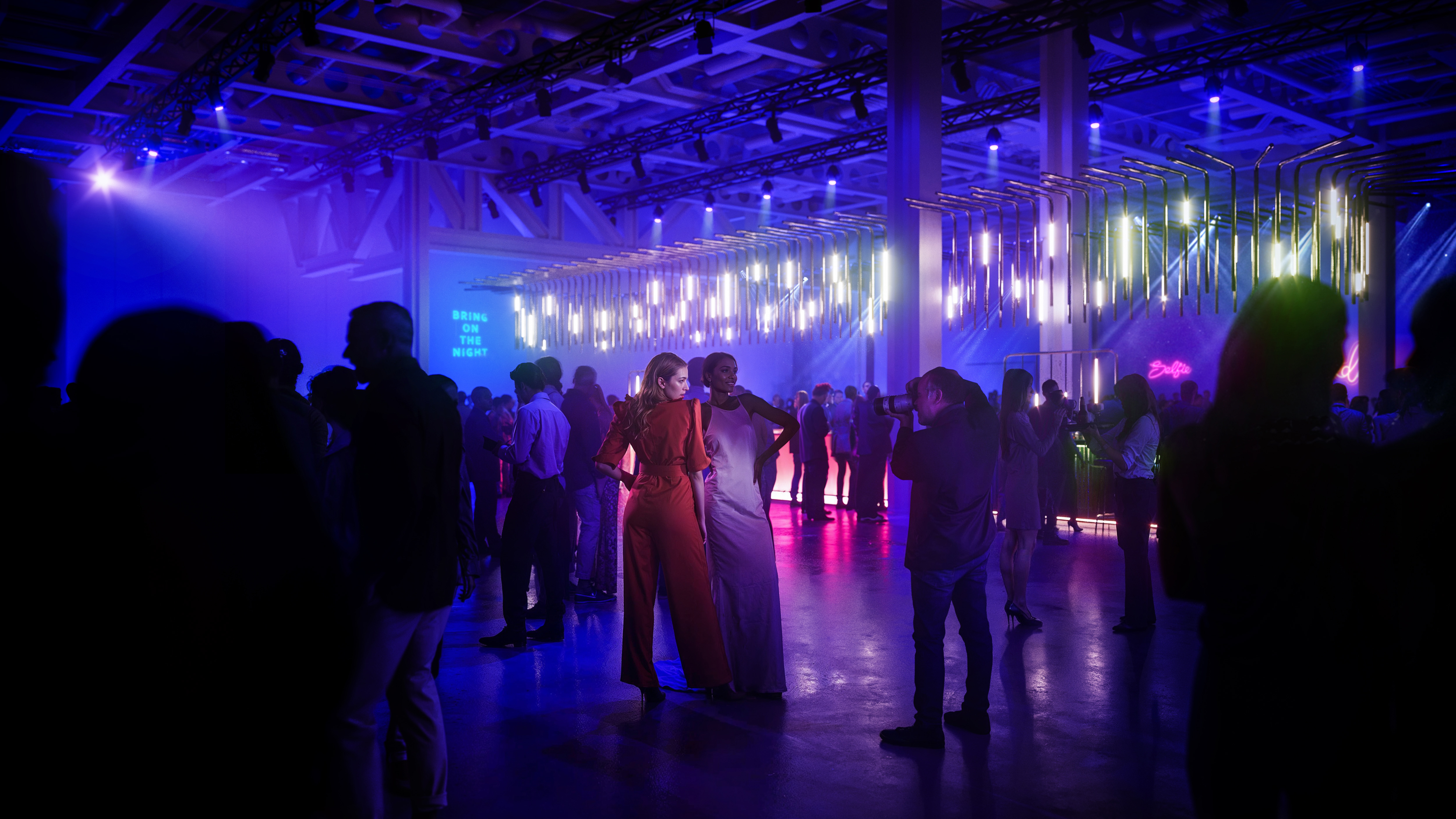 Vibrant West Hall event space with dynamic lighting for networking and celebrations.