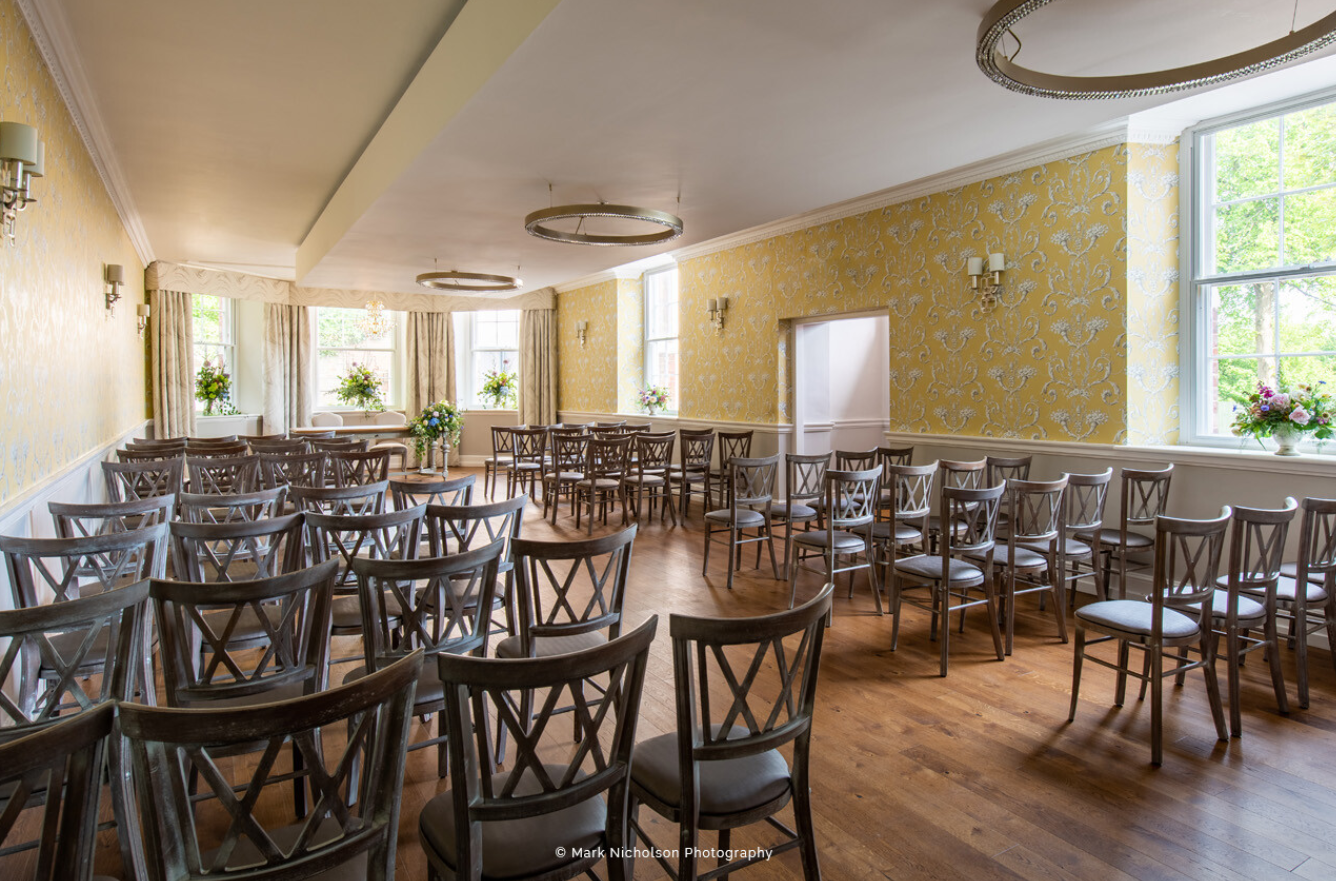 Elegant wedding venue with wooden chairs and warm ambiance at Old Palace Chester.
